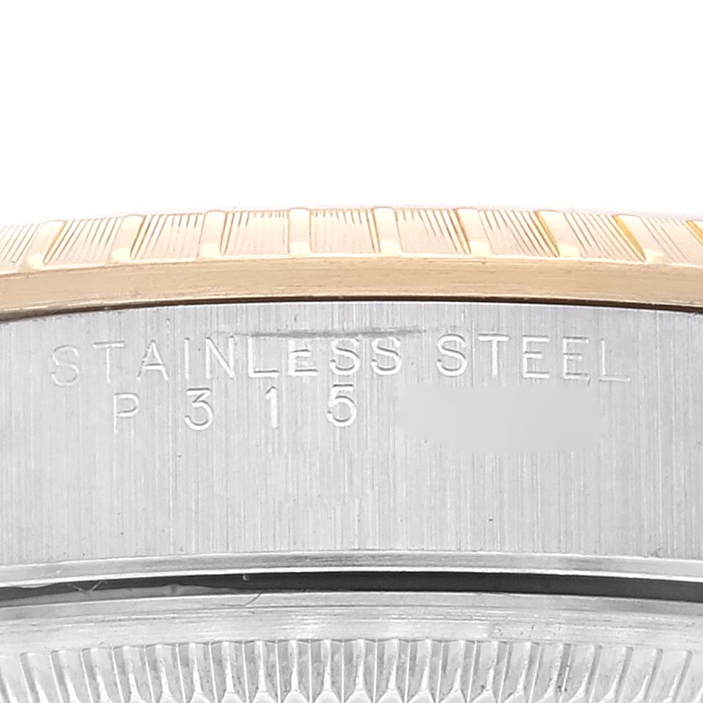 This image shows the stainless steel case back engraving and part of the fluted bezel of a Rolex Date 15223 Men's Steel and Gold (two tone) Champagne Dial 15223 Men's Steel and Gold (two tone) Champagne Dial model watch.