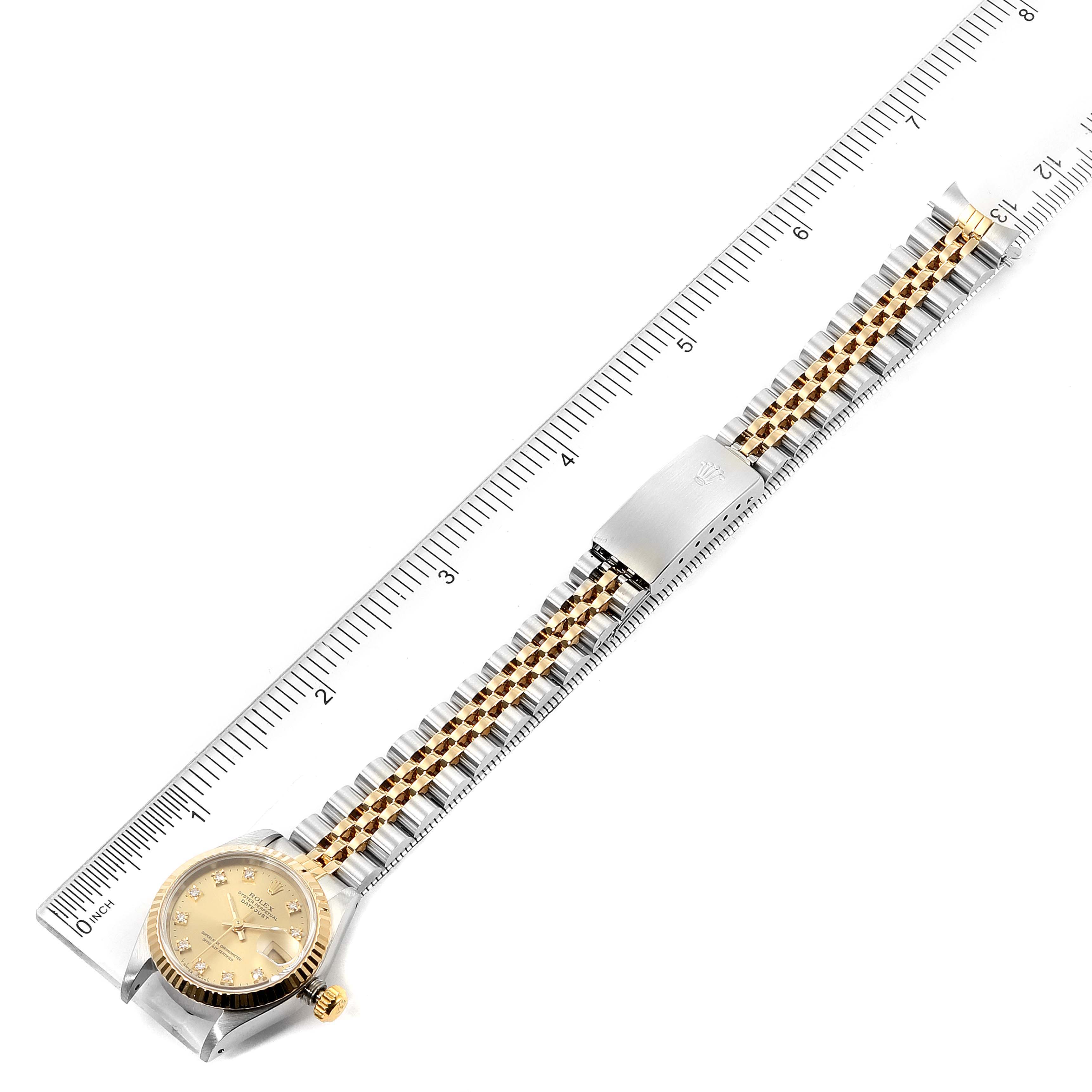 This image shows a Rolex Datejust 69173 Women's Steel and Gold (two tone) Champagne Dial 69173 Women's Steel and Gold (two tone) Champagne Dial watch in a top-down view, featuring its full length and positioned alongside a ruler for size reference.