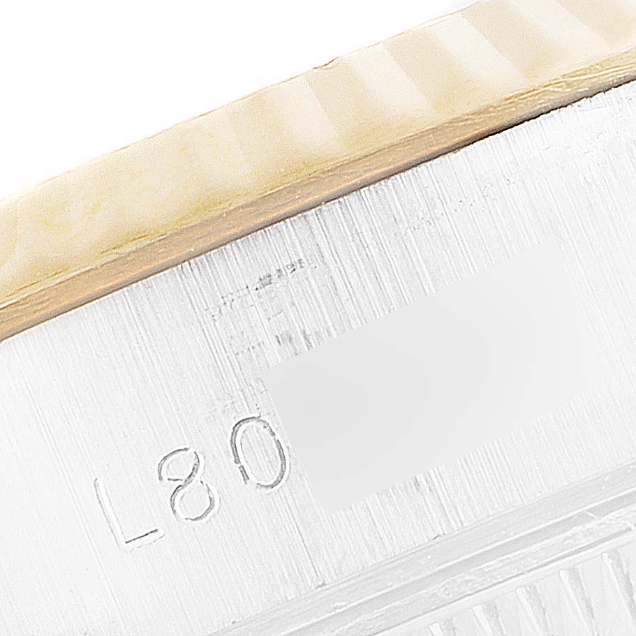 This close-up image shows part of the fluted bezel and case of a Rolex Datejust 69173 Women's Steel and Gold (two tone) Blue Dial 69173 Women's Steel and Gold (two tone) Blue Dial watch.