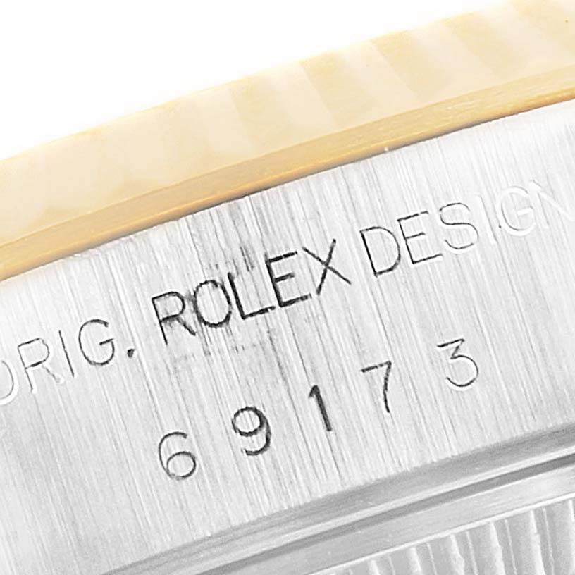 The image shows a close-up of the case side of a Rolex Datejust 69173 Women's Steel and Gold (two tone) Champagne Dial 69173 Women's Steel and Gold (two tone) Champagne Dial, highlighting the branding and part of the bezel.