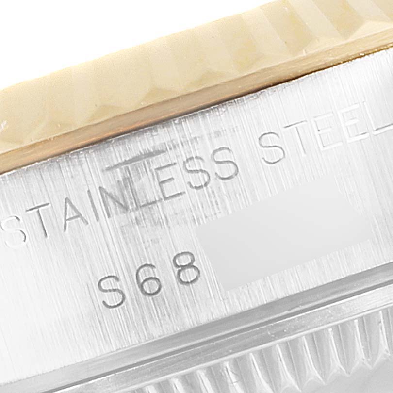 This close-up shows the engraved stainless steel part of the case on a Rolex Datejust 69173 Women's Steel and Gold (two tone) Champagne Dial 69173 Women's Steel and Gold (two tone) Champagne Dial watch.