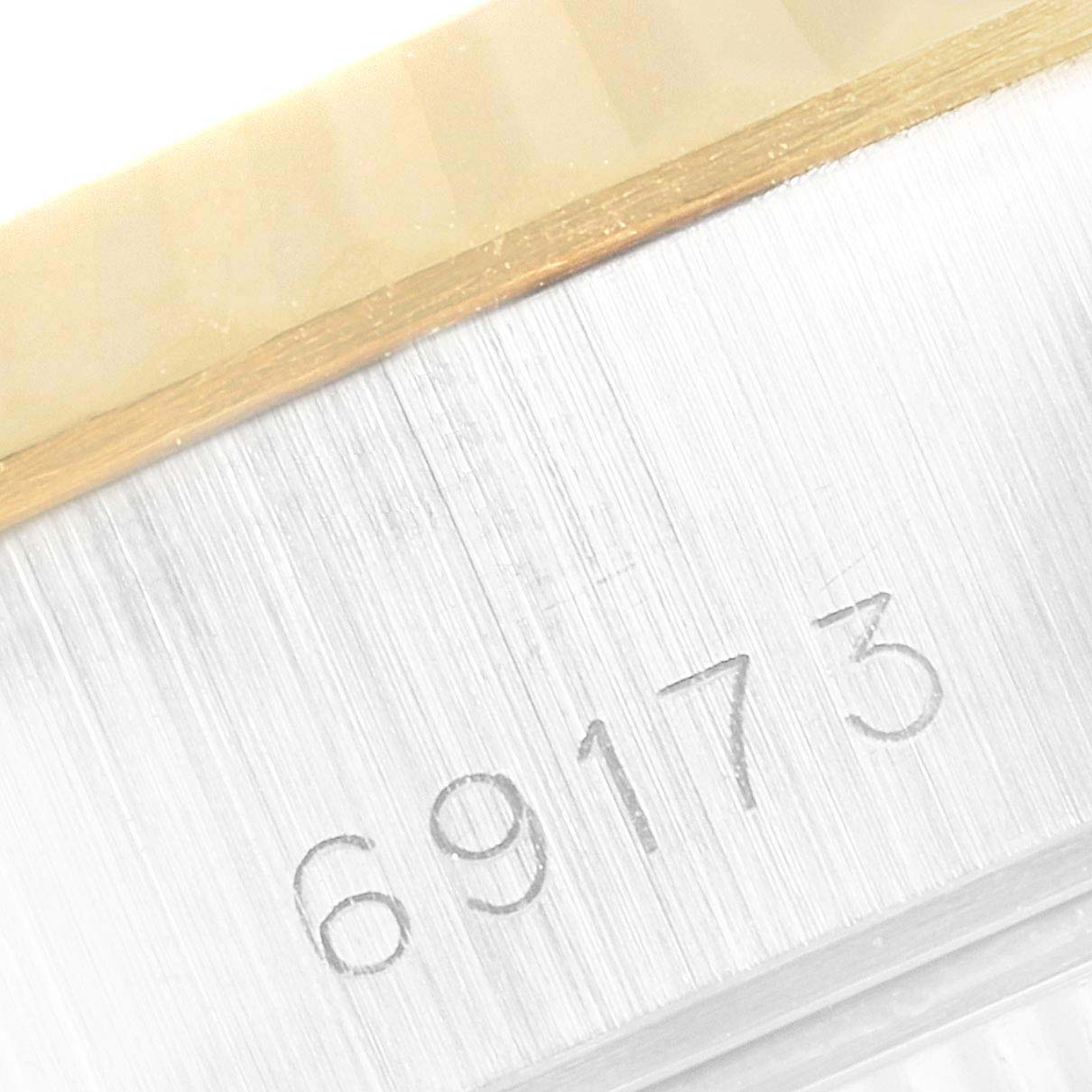 This close-up image shows the model number "69173" engraved on the side of a Rolex Datejust 69173 Women's Steel and Gold (two tone) Champagne Dial 69173 Women's Steel and Gold (two tone) Champagne Dial watch case.