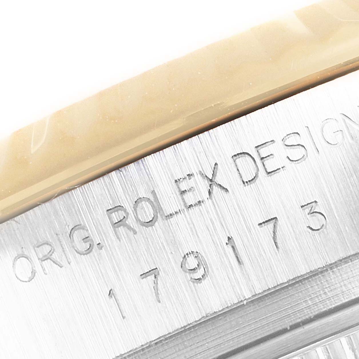 The image shows a close-up of the engraved case back of a Rolex Datejust 179173 Women's Steel and Gold (two tone) Mother of Pearl Dial 179173 Women's Steel and Gold (two tone) Mother of Pearl Dial watch.