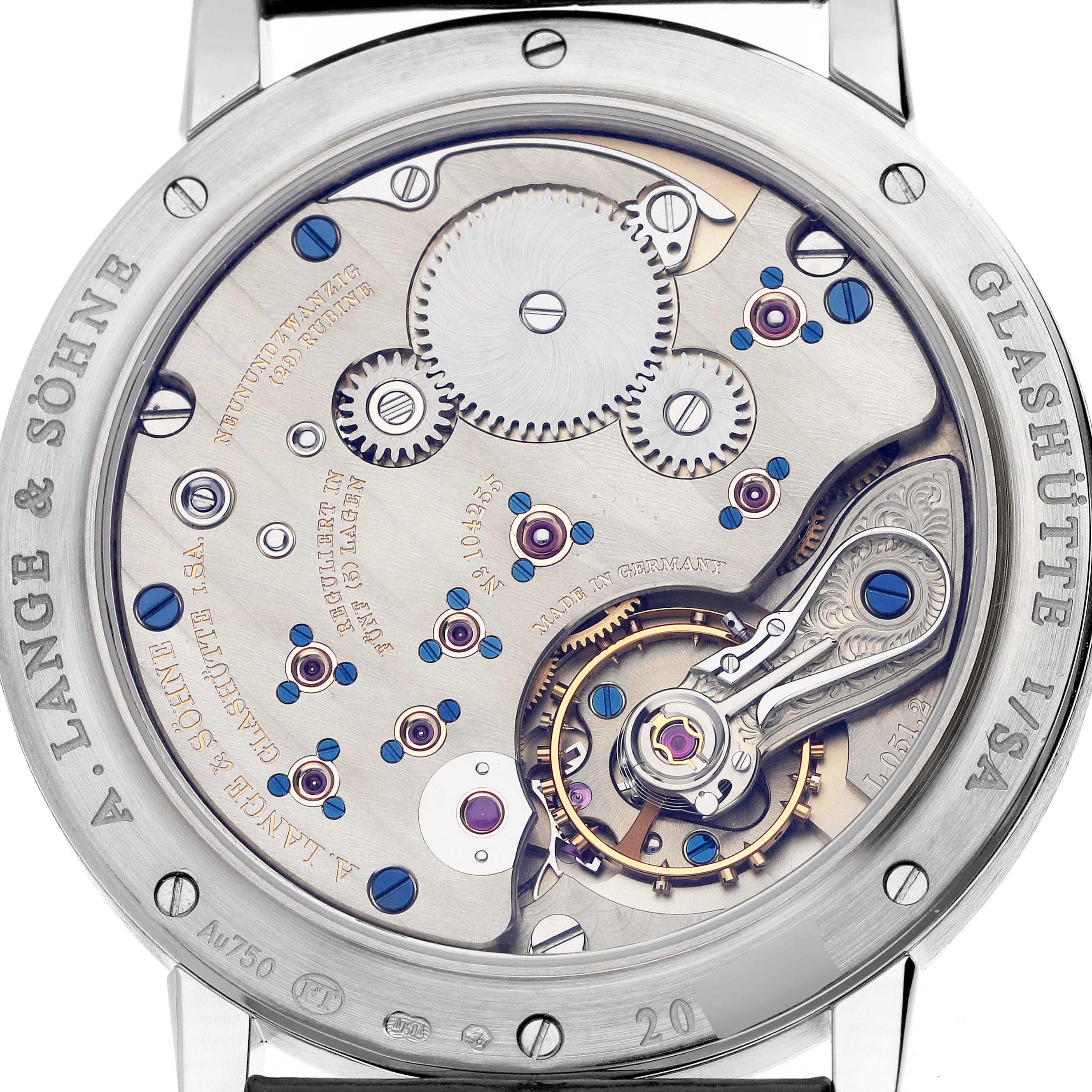 The image shows the back of the A. Lange & Sohne 1815 234.026 Men's White Gold Silver Dial watch, highlighting its intricate movement and gears.