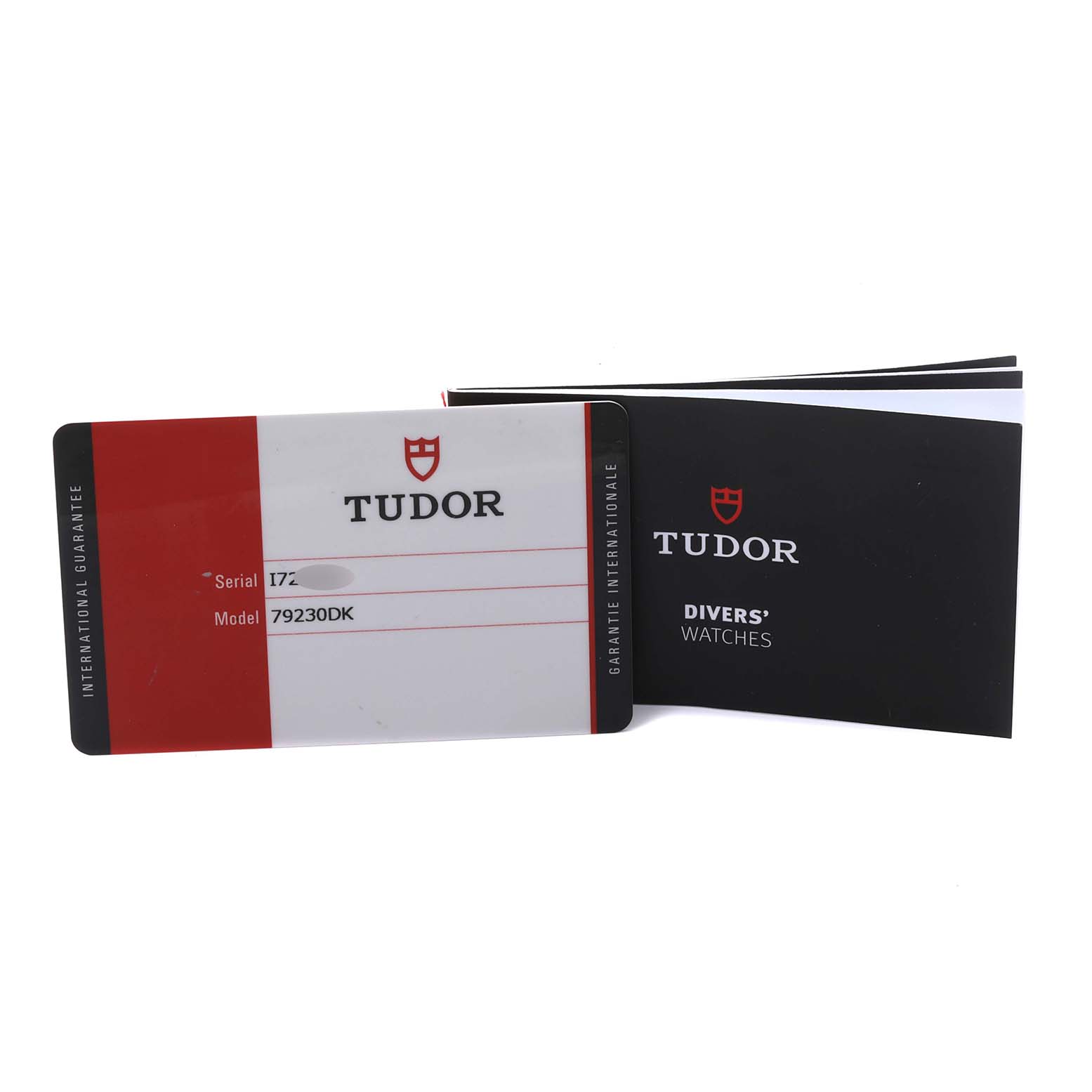 The image shows the international guarantee card and booklet for the Tudor Heritage Black Bay 79230DK Men's Stainless Steel Black Dial 79230DK Men's Stainless Steel Black Dial model.