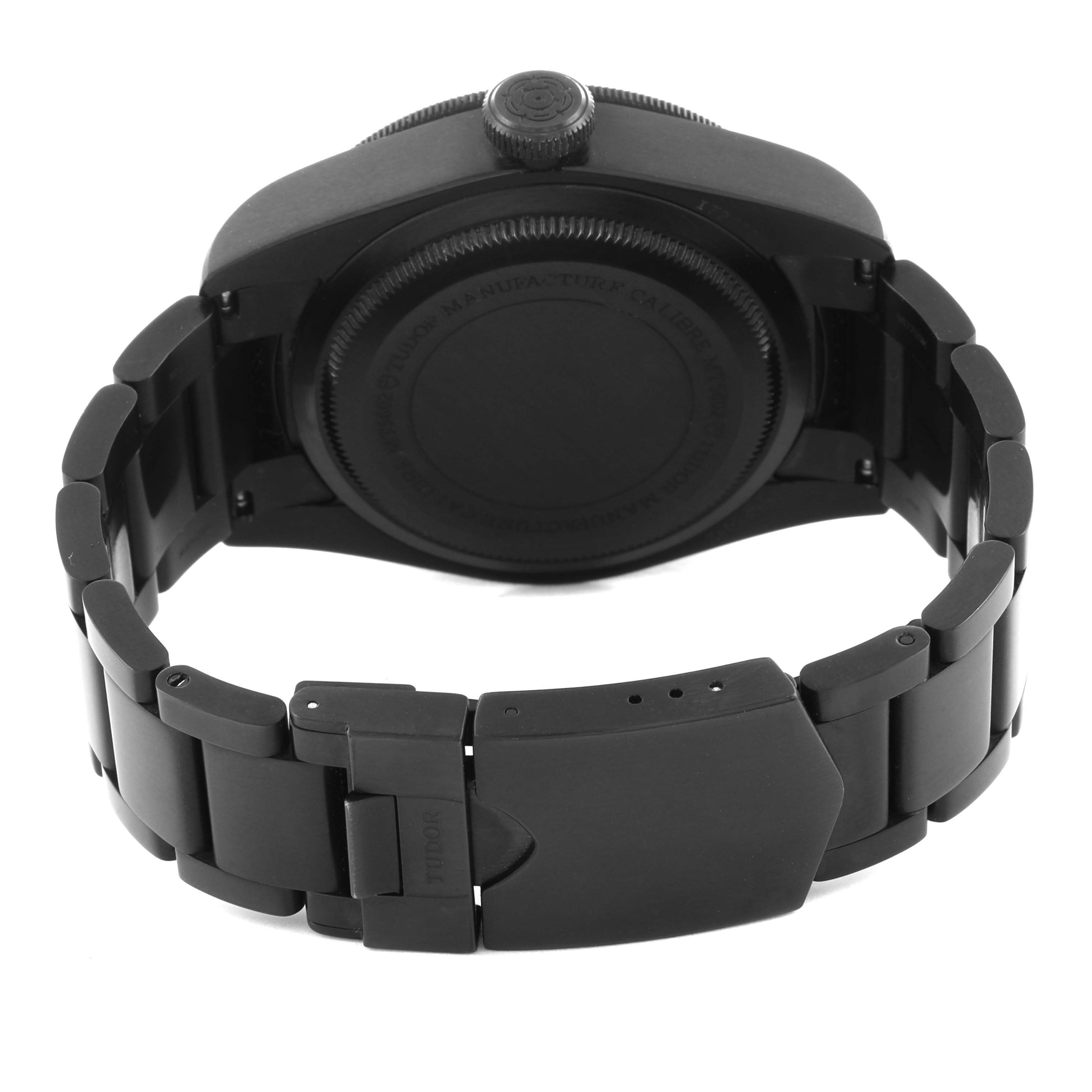 The image shows the back view of a Tudor Heritage Black Bay 79230DK Men's Stainless Steel Black Dial 79230DK Men's Stainless Steel Black Dial watch, highlighting the case back and bracelet clasp.