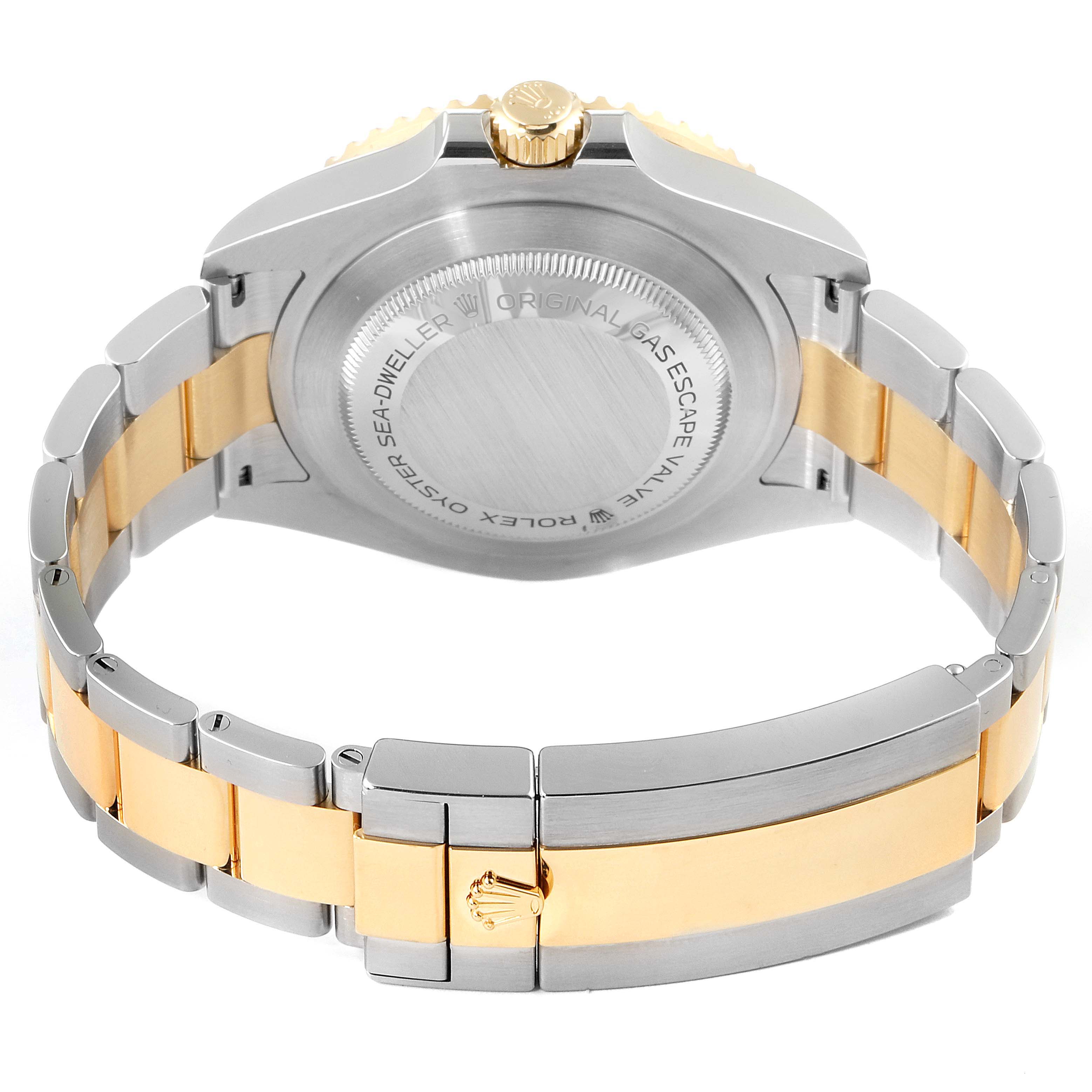 This image shows the back angle of the Rolex Sea-Dweller 126603 Men's Steel and Gold (two tone) Black Dial 126603 Men's Steel and Gold (two tone) Black Dial watch, highlighting its case back and two-tone bracelet.