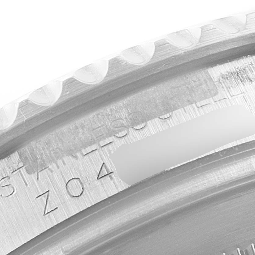 This close-up image shows the engraved details on the bezel and case of a Rolex Yacht-Master 16622 Men's Stainless Steel Silver Dial 16622 Men's Stainless Steel Silver Dial watch.