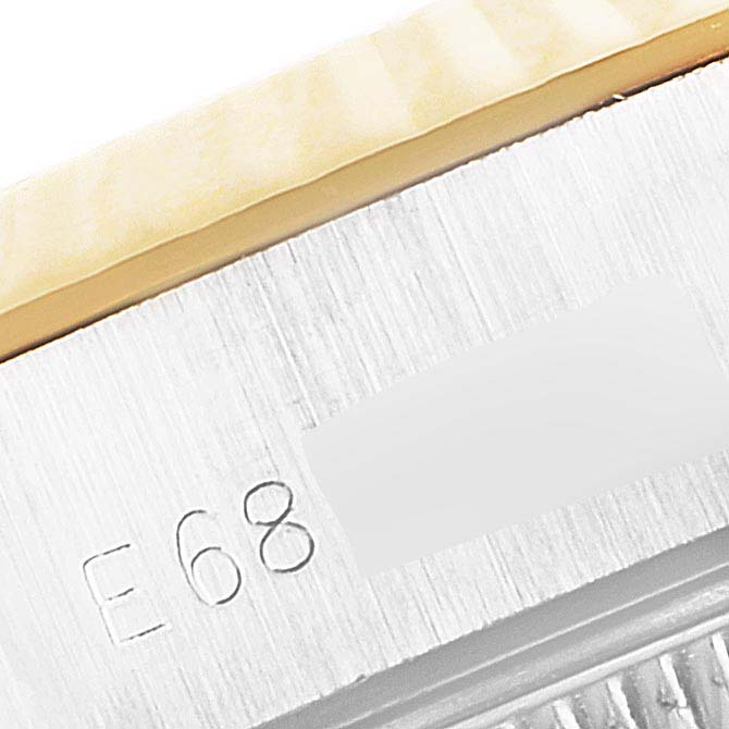 This image shows a close-up of the serial number engraving and part of the bezel of a Rolex Datejust 69173 Women's Steel and Gold (two tone) Champagne Dial 69173 Women's Steel and Gold (two tone) Champagne Dial watch.