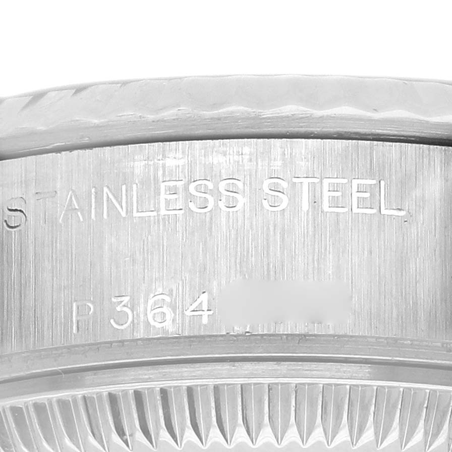 The image shows a close-up of the side and flange of a Rolex Datejust 79174 Women's Stainless Steel Black Dial 79174 Women's Stainless Steel Black Dial, highlighting the stainless steel engravings.