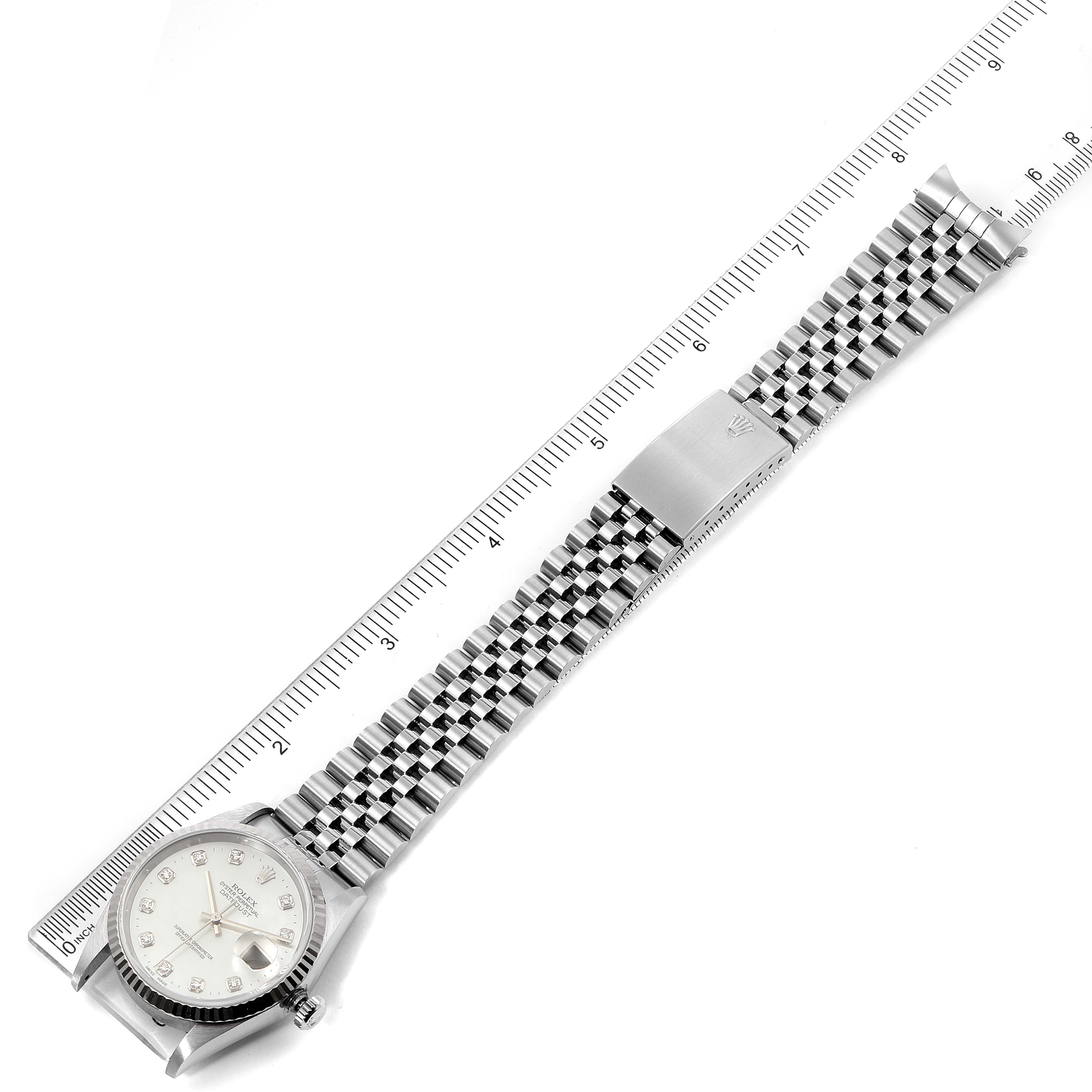 The image shows a top-down view of a Rolex Datejust 16234 Men's Stainless Steel Mother of Pearl Dial 16234 Men's Stainless Steel Mother of Pearl Dial watch, featuring the face, bracelet, and clasp, aligned next to a ruler.