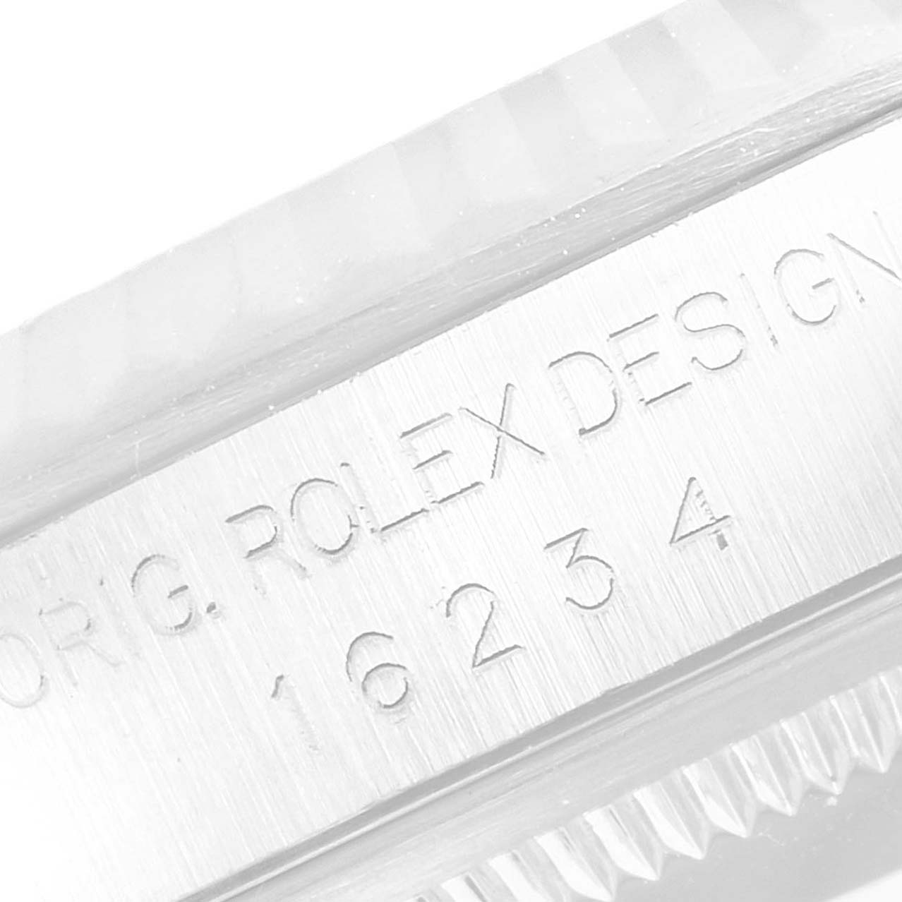 The image shows a close-up of the engraved serial number and text on the case side of a Rolex Datejust 16234 Men's Stainless Steel Mother of Pearl Dial 16234 Men's Stainless Steel Mother of Pearl Dial watch.