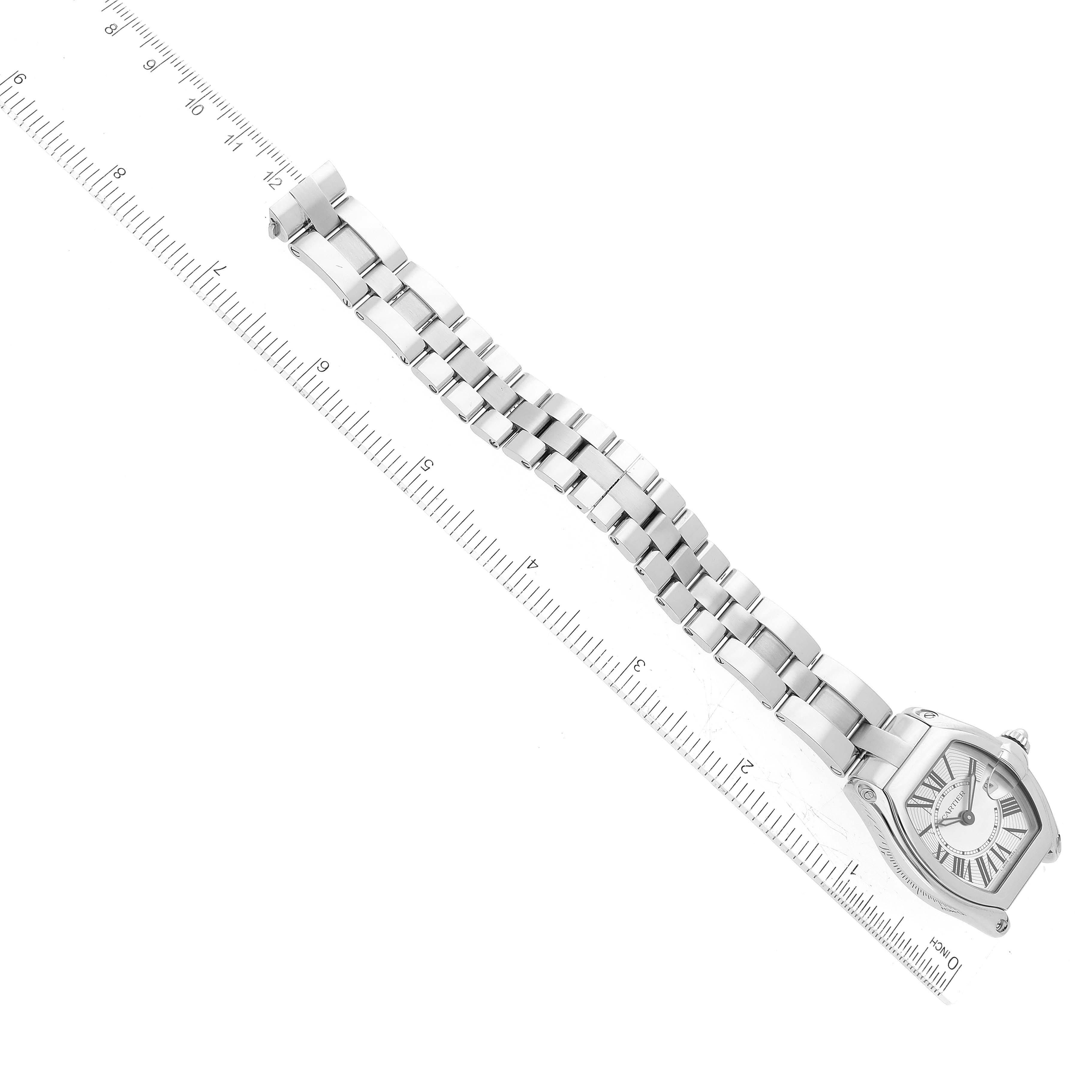 The image shows a full view of the Cartier Roadster W62016V3 Women's Stainless Steel Silver Dial W62016V3 Women's Stainless Steel Silver Dial watch and its metal bracelet, placed on a ruler for size reference.