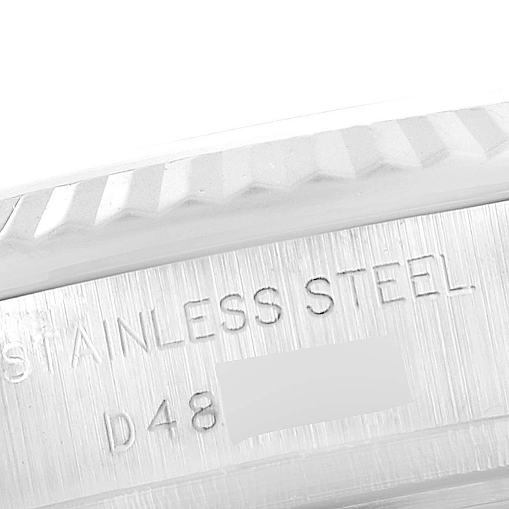 This image shows a close-up of the engraved stainless steel case of a Rolex Datejust 179174 Women's Stainless Steel Silver Dial 179174 Women's Stainless Steel Silver Dial watch.