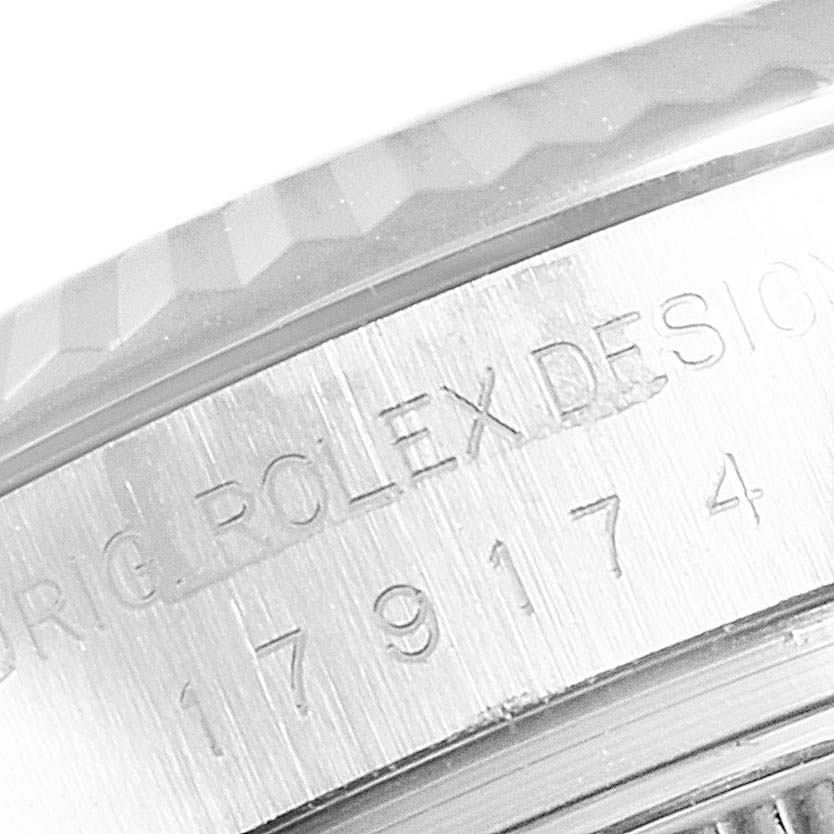 The image shows a close-up of a Rolex Datejust 179174 Women's Stainless Steel Silver Dial 179174 Women's Stainless Steel Silver Dial watch case, highlighting the engraved text on the stainless steel surface.