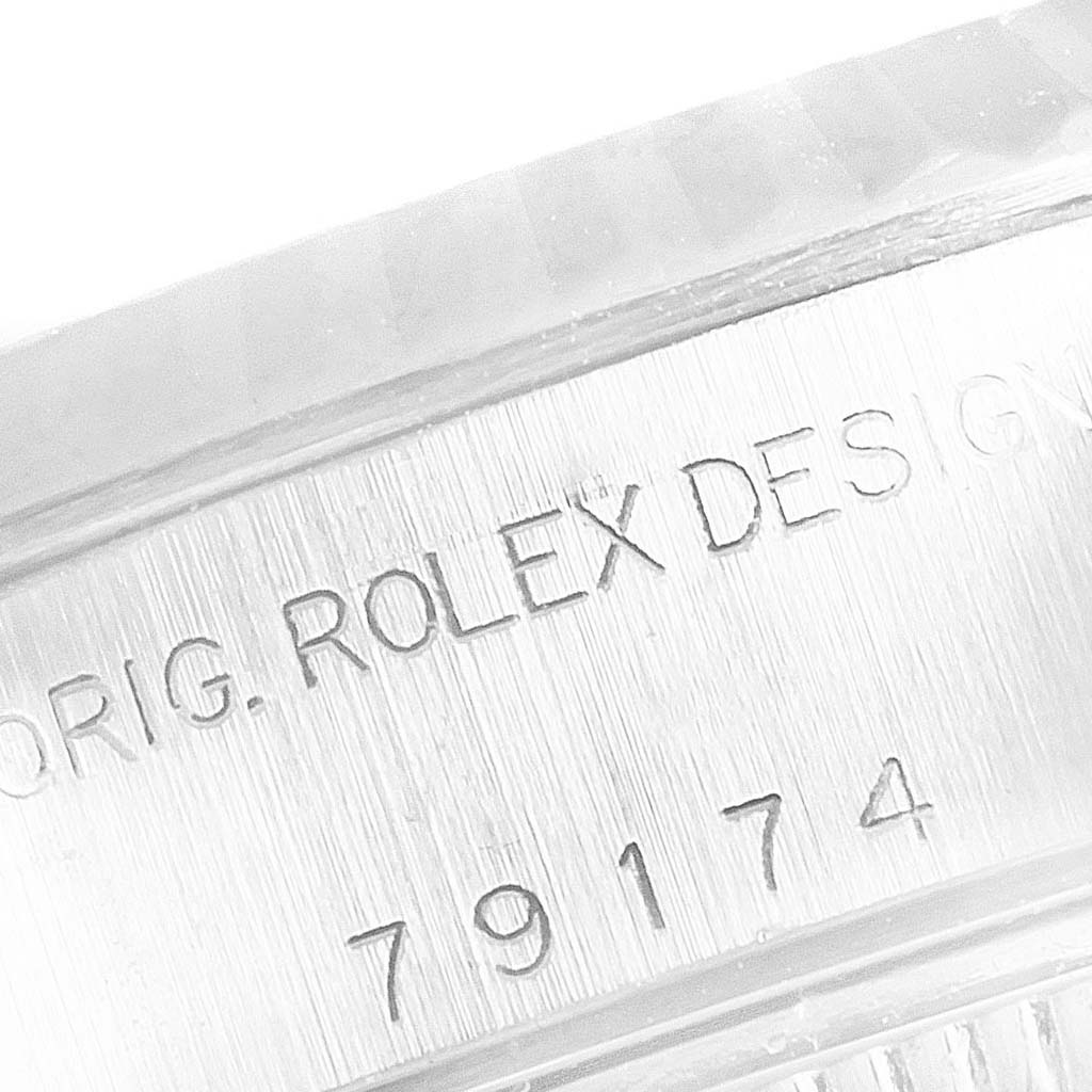 The image shows a close-up of the serial number and "ORIG. ROLEX DESIGN" engraving on the side of a Rolex Datejust 79174 Women's Stainless Steel Pink Dial 79174 Women's Stainless Steel Pink Dial watch case.