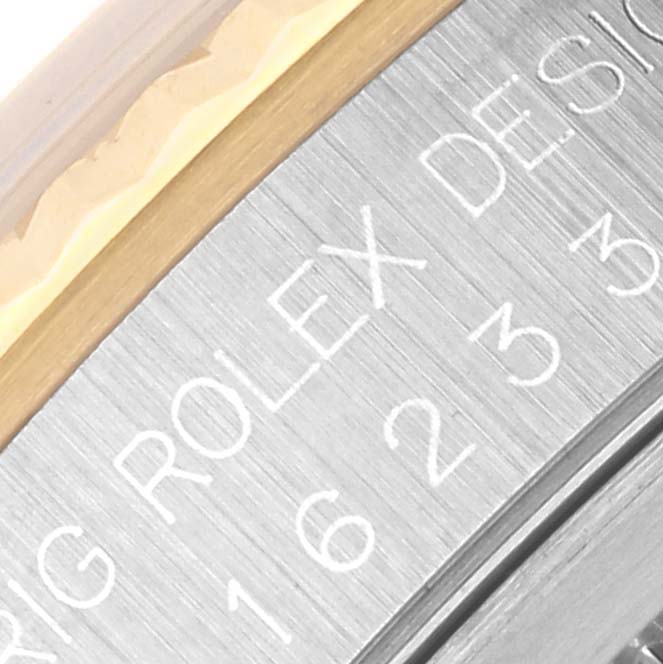The image shows a close-up of the side engraving on the bezel of the Rolex Datejust 16233 Men's Steel and Gold (two tone) White Dial 16233 Men's Steel and Gold (two tone) White Dial watch.