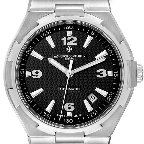 The image shows a front view of the Vacheron Constantin Overseas 47040/B01A-9094 Men's Stainless Steel Black Dial 47040/B01A-9094 Men's Stainless Steel Black Dial watch, highlighting its black dial, silver markers, hands, and date display.