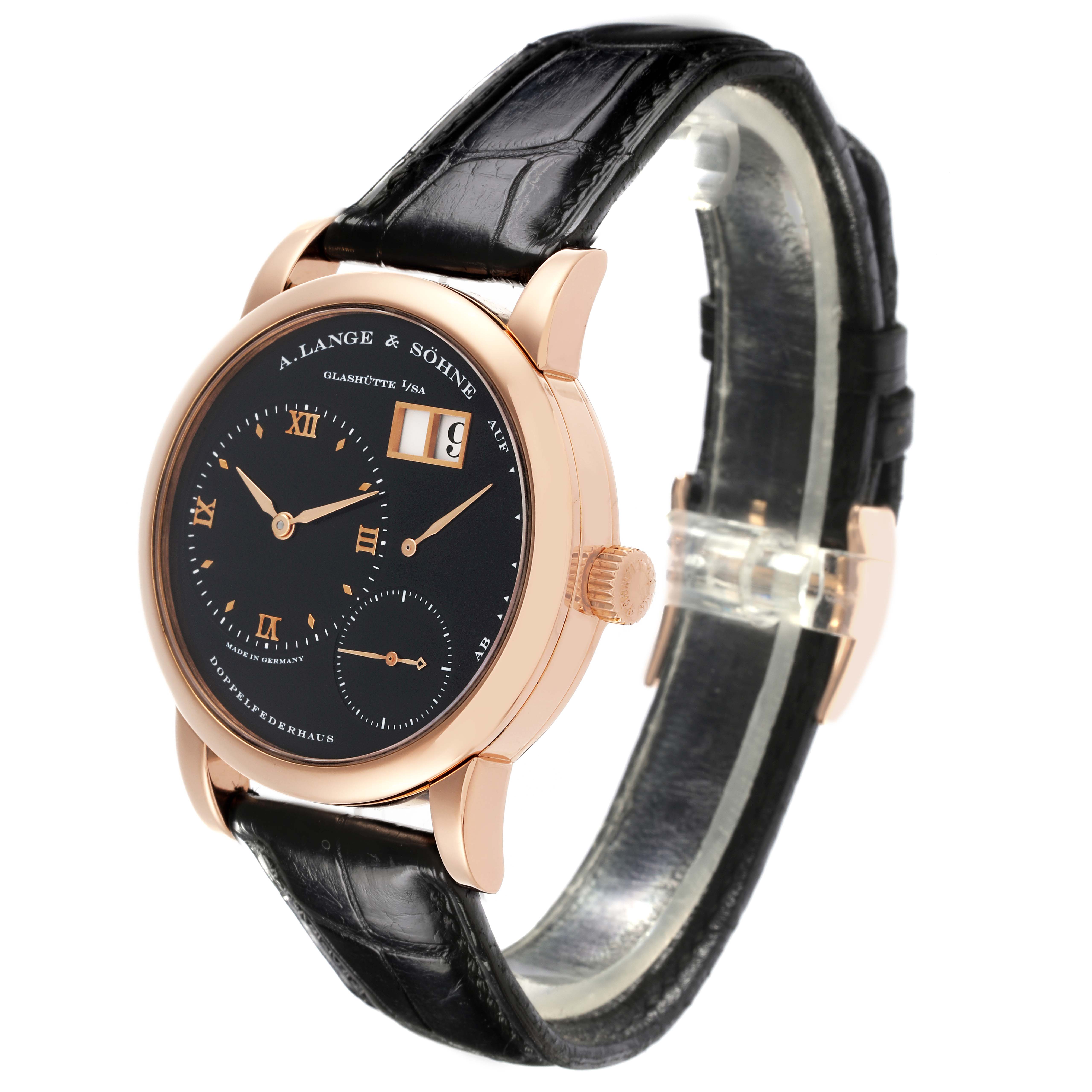 The Lange 1 watch by A. Lange & Söhne is shown at a slight angle, highlighting the black dial, gold case, and leather strap.