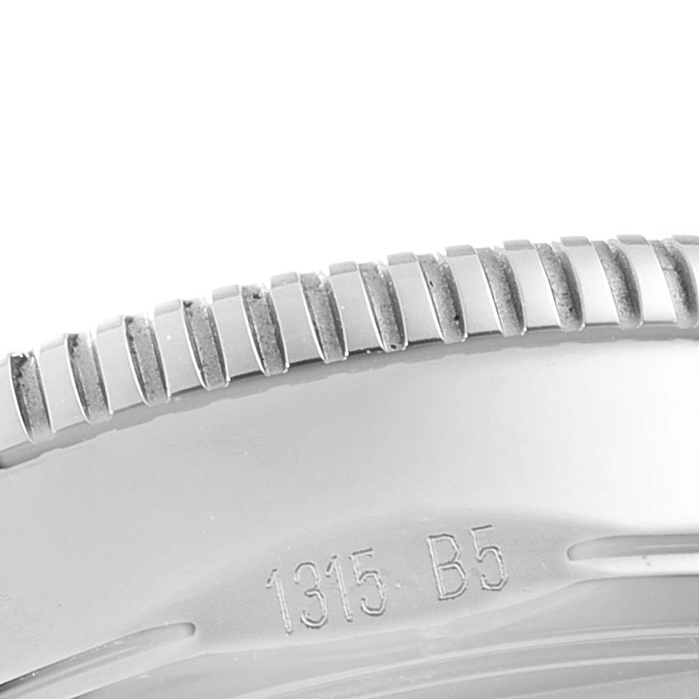 This image shows a close-up of the bezel with ridges and partial engraving on a Breitling Superocean A17321 Men's Stainless Steel Black Dial A17321 Men's Stainless Steel Black Dial watch.