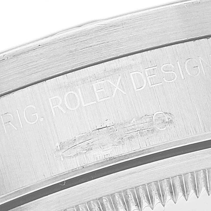 This close-up image shows the engraved detail on the casing of a Rolex Date 15210 Men's Stainless Steel Black Dial 15210 Men's Stainless Steel Black Dial model watch.