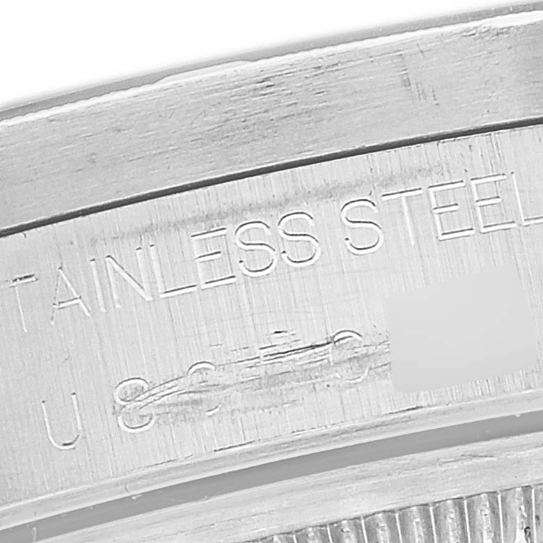 The angle shows a close-up of the inner case back of the Rolex Date 15210 Men's Stainless Steel Black Dial 15210 Men's Stainless Steel Black Dial watch, highlighting the "STAINLESS STEEL" engraving.