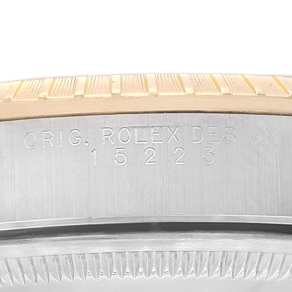 This image shows a close-up of the engraved case reference number on a Rolex Date 15223 Men's Steel and Gold (two tone) Blue Dial 15223 Men's Steel and Gold (two tone) Blue Dial model watch.