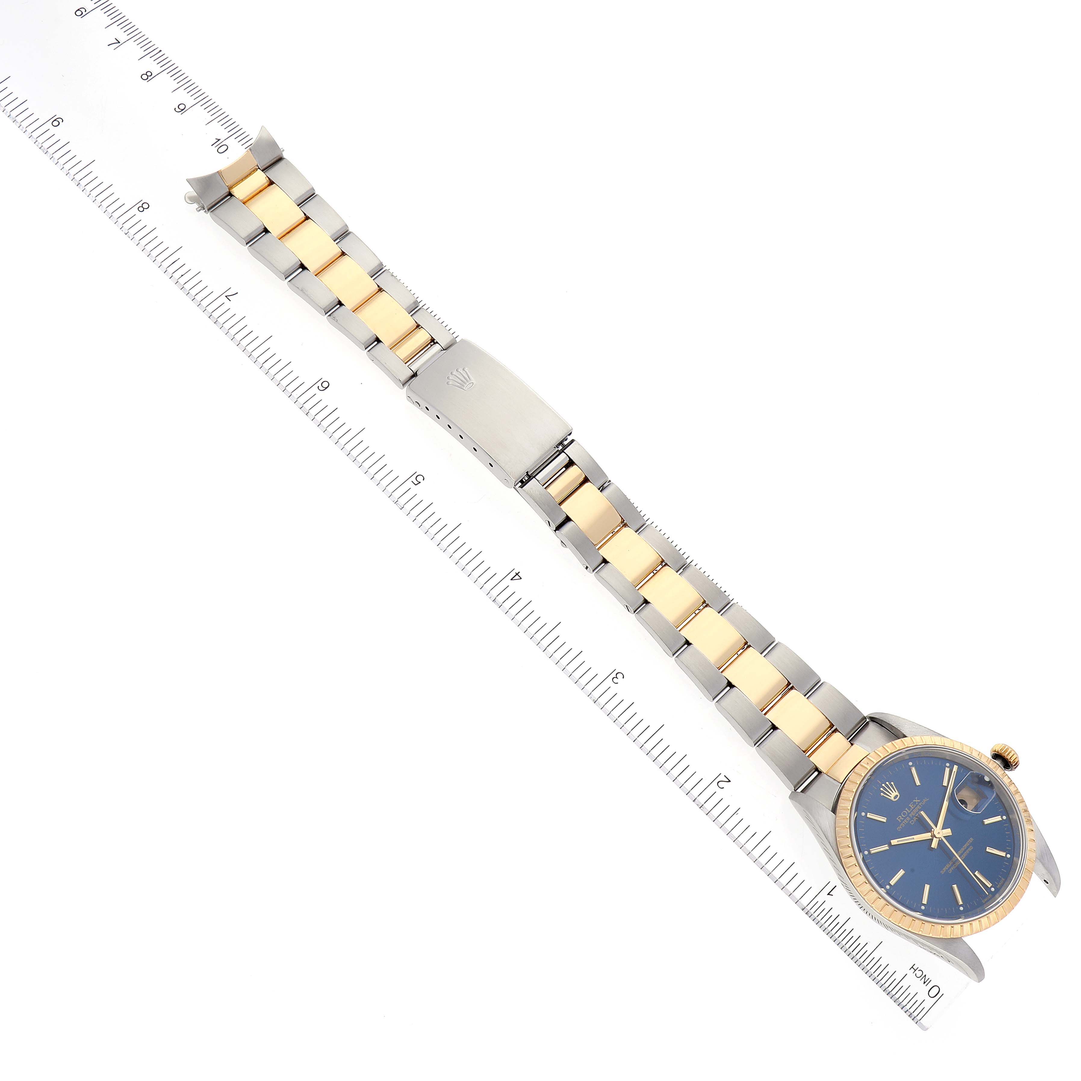 The Rolex Date 15223 Men's Steel and Gold (two tone) Blue Dial 15223 Men's Steel and Gold (two tone) Blue Dial model watch is shown from above, displaying the full band with a ruler alongside for scale.