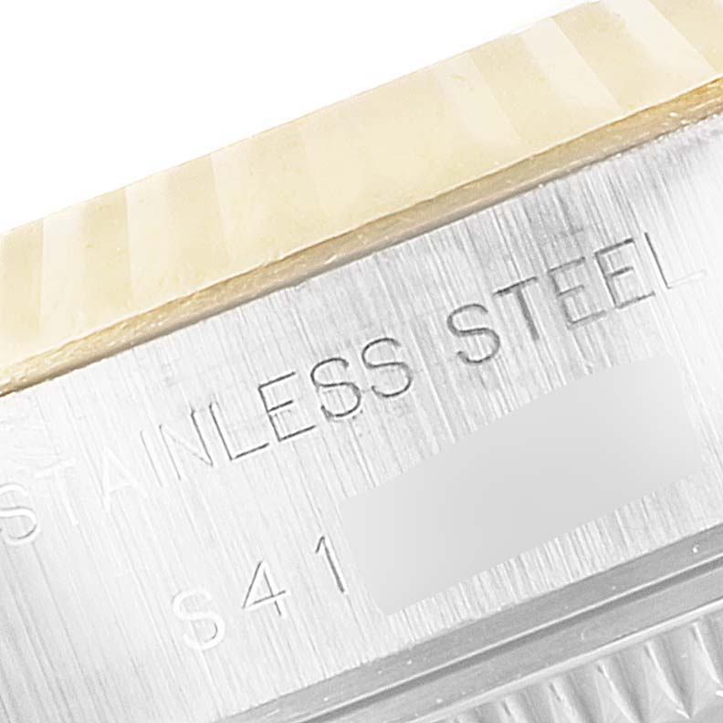 This image shows a close-up angle of the stainless steel casing and fluted bezel of a Rolex Datejust 69173 Women's Steel and Gold (two tone) Champagne Dial 69173 Women's Steel and Gold (two tone) Champagne Dial watch.