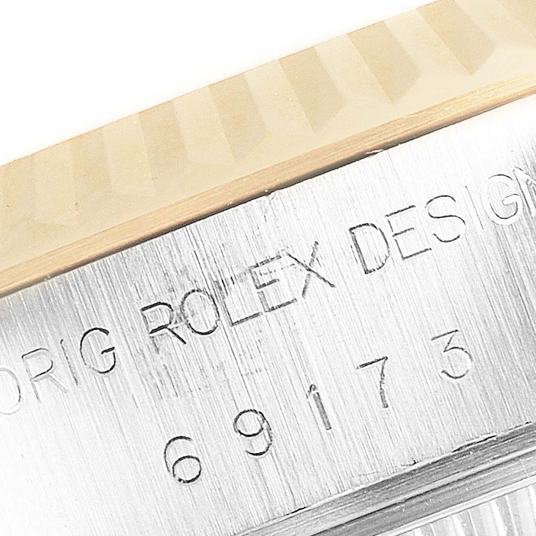 This close-up image shows the engraved side of the Rolex Datejust 69173 Women's Steel and Gold (two tone) Blue Dial 69173 Women's Steel and Gold (two tone) Blue Dial watch case, including the model number and design details.