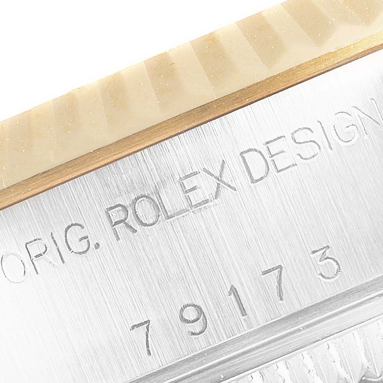 The image shows a close-up of the Rolex Datejust 79173 Women's Steel and Gold (two tone) Mother of Pearl Dial 79173 Women's Steel and Gold (two tone) Mother of Pearl Dial model's bezel and case engraving.