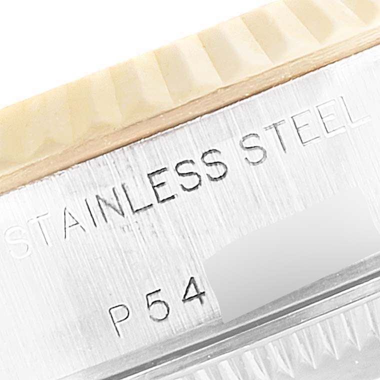 This close-up image shows the side engraving of a stainless steel Rolex Datejust 79173 Women's Steel and Gold (two tone) Mother of Pearl Dial 79173 Women's Steel and Gold (two tone) Mother of Pearl Dial watch, highlighting part of the bezel and case. 