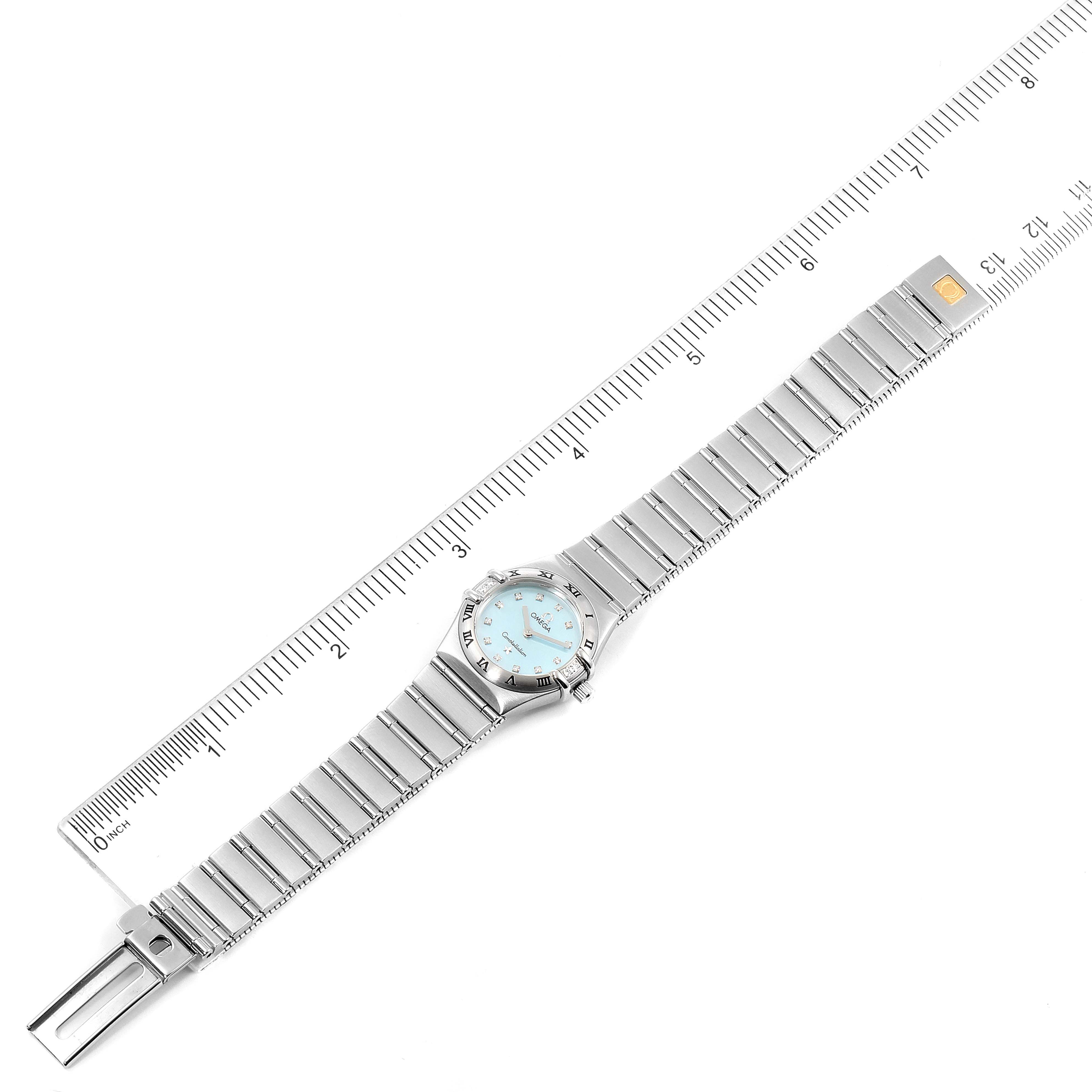 The Omega 1567.86.00 Women's Stainless Steel Mother of Pearl Dial 1567.86.00 Women's Stainless Steel Mother of Pearl Dial Constellation Mini Blue MOP Diamonds Ladies Watch 1567.86.00 model is shown fully extended with a ruler for measurement.