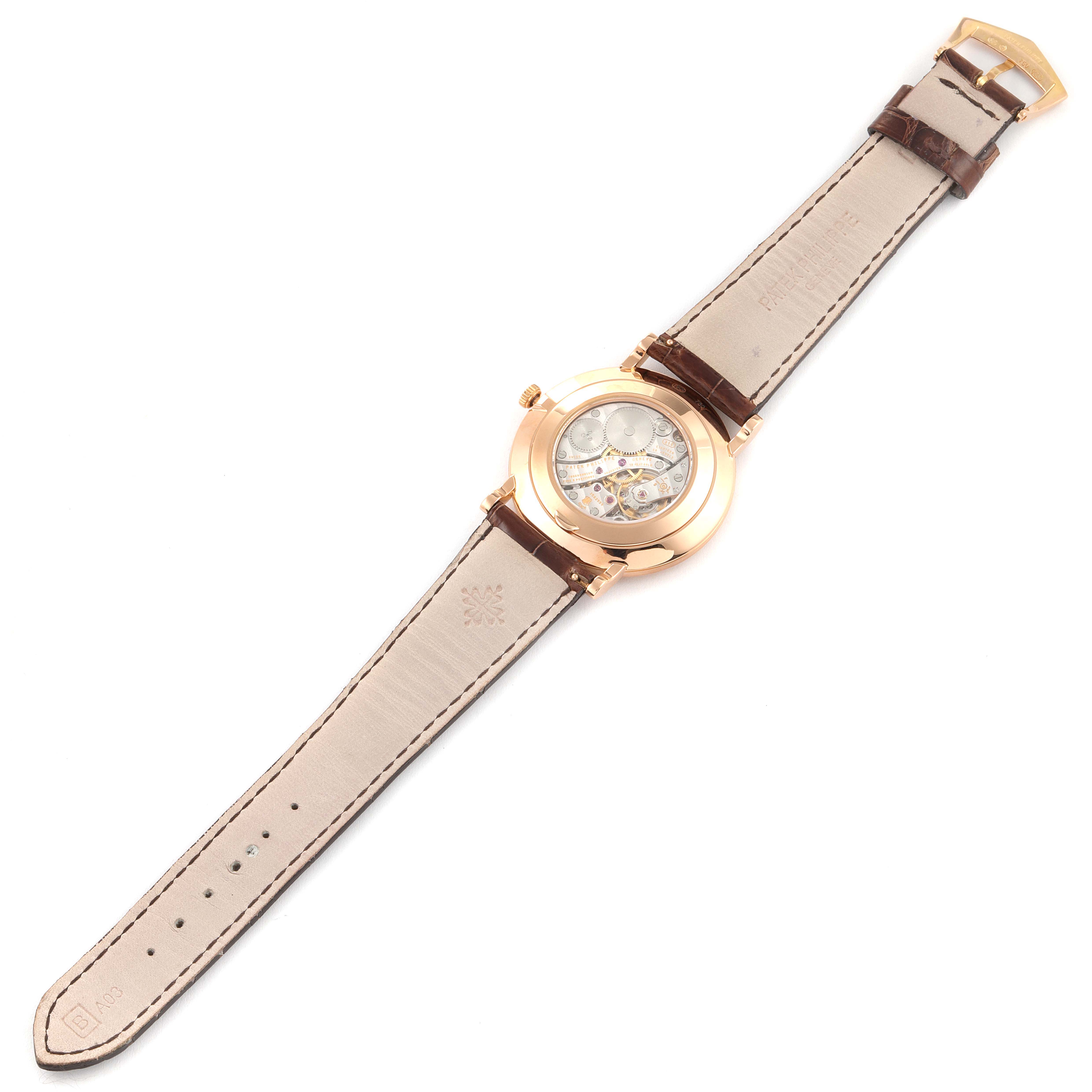 This is a rear view of a Patek Philippe Calatrava 5119R Men's Rose Gold White Dial 5119R Men's Rose Gold White Dial watch showing the movement and leather strap.