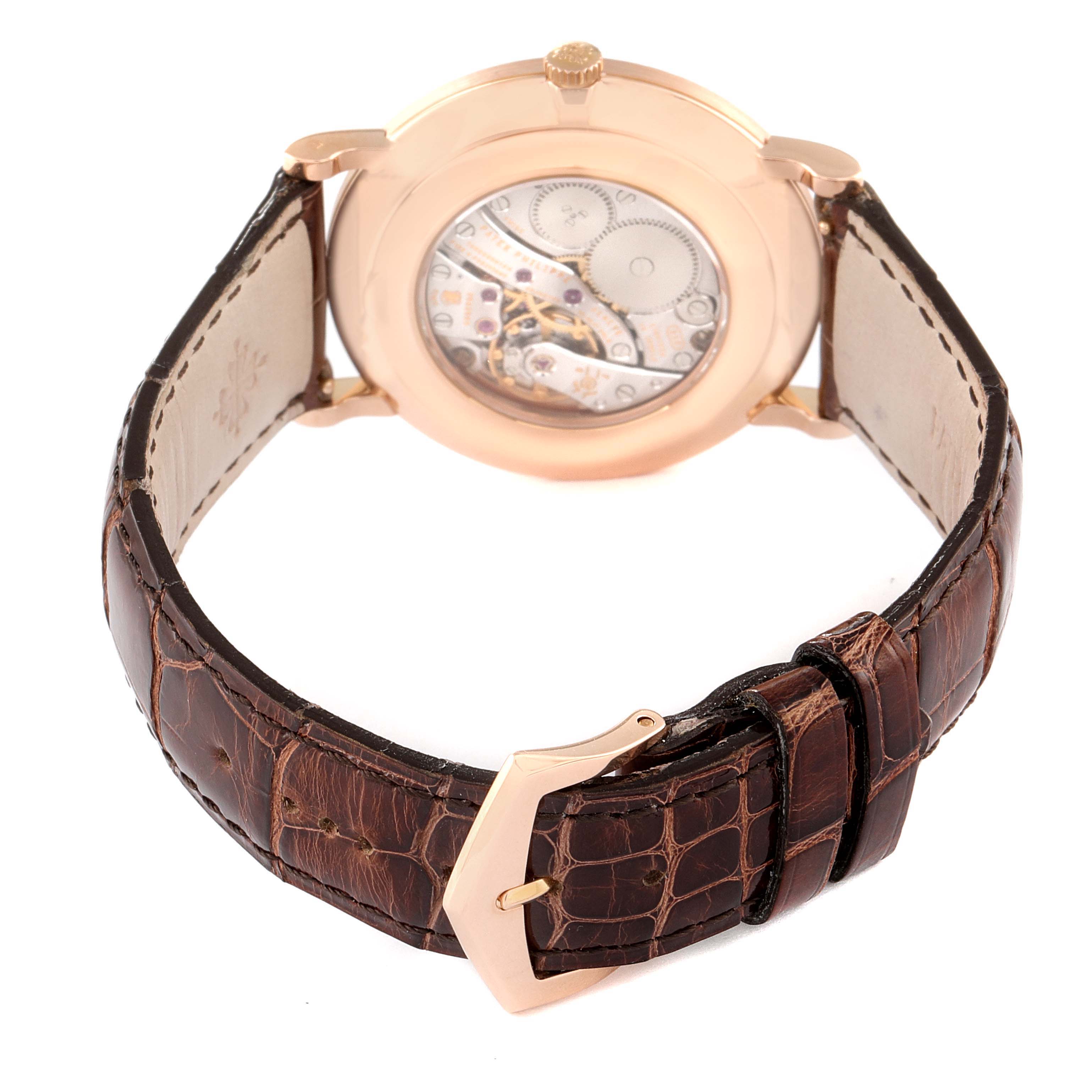 This image shows the back view of a Patek Philippe Calatrava 5119R Men's Rose Gold White Dial 5119R Men's Rose Gold White Dial watch, highlighting its transparent case back and leather strap.