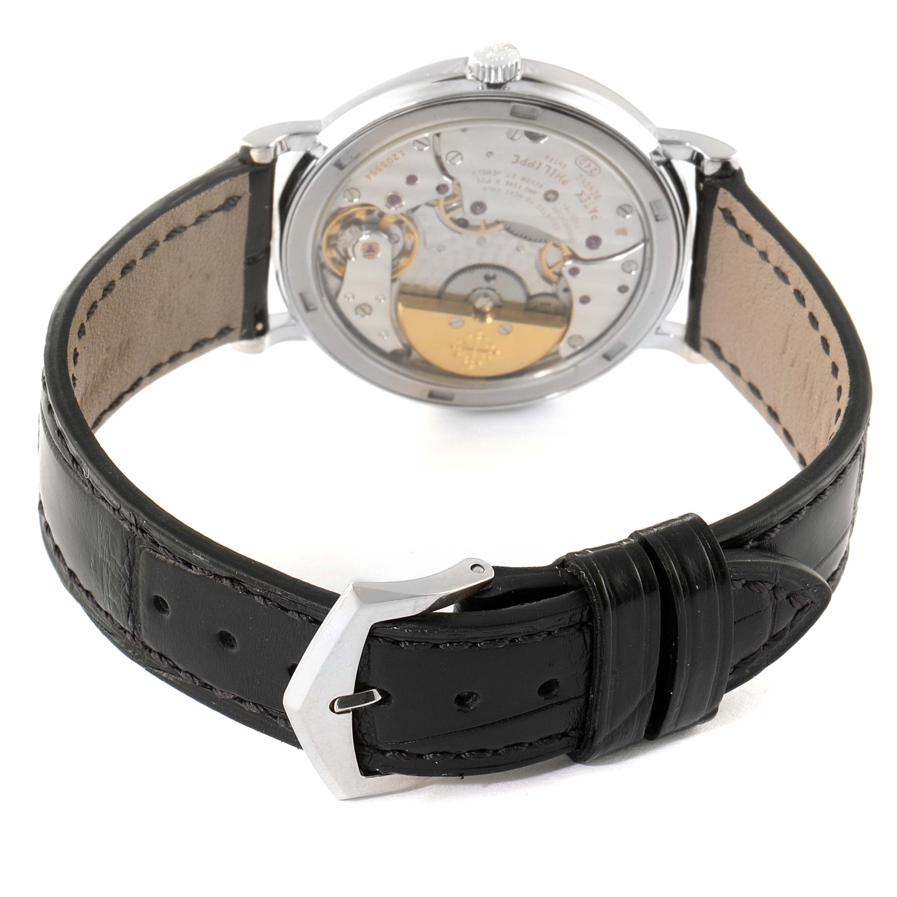 The image shows the back view of a Patek Philippe Calatrava 5120G Men's White Gold White Dial 5120G Men's White Gold White Dial watch, highlighting the mechanical movement and a black leather strap.