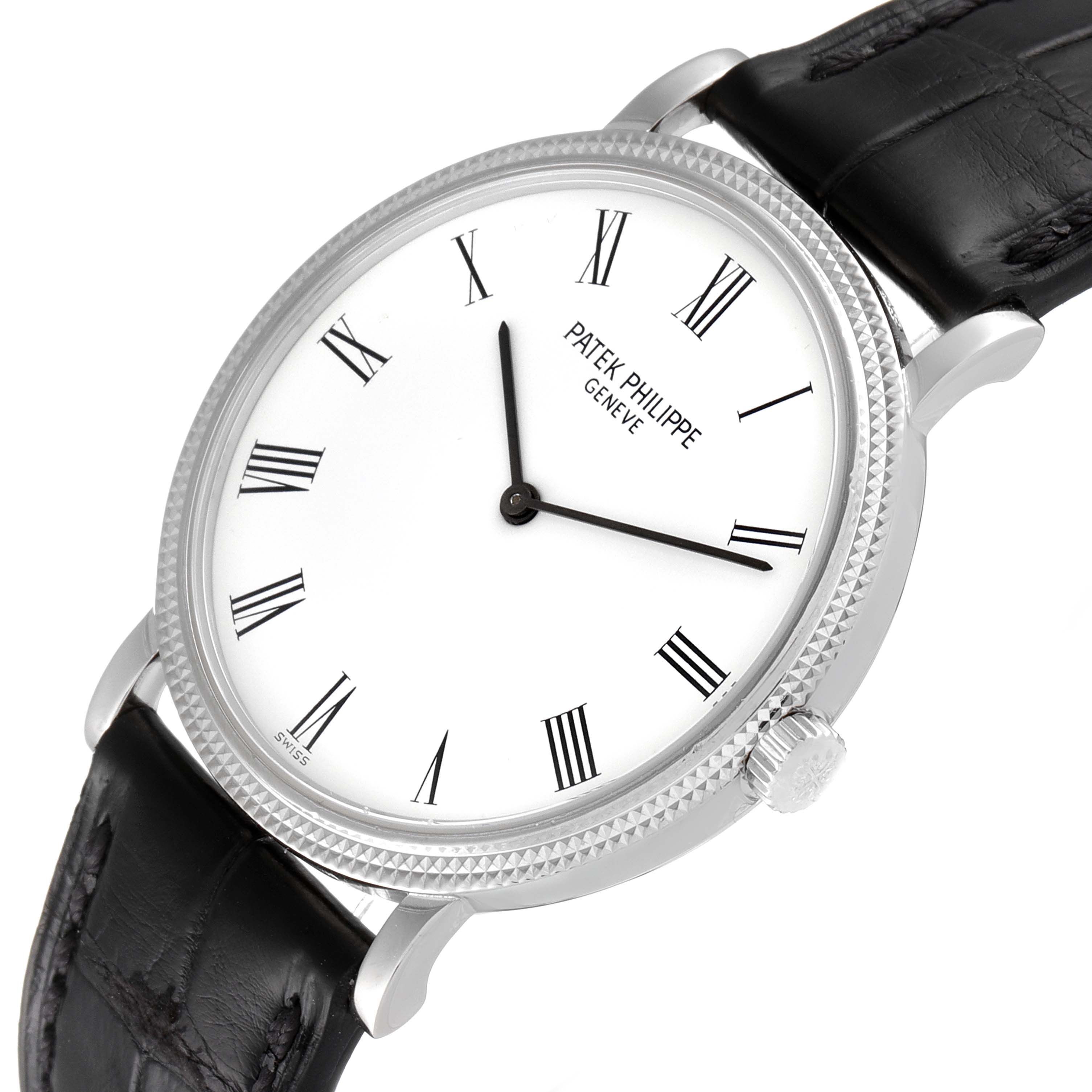 The image shows a Patek Philippe Calatrava 5120G Men's White Gold White Dial 5120G Men's White Gold White Dial watch from an angled perspective, highlighting the dial, bezel, crown, and part of the black strap.