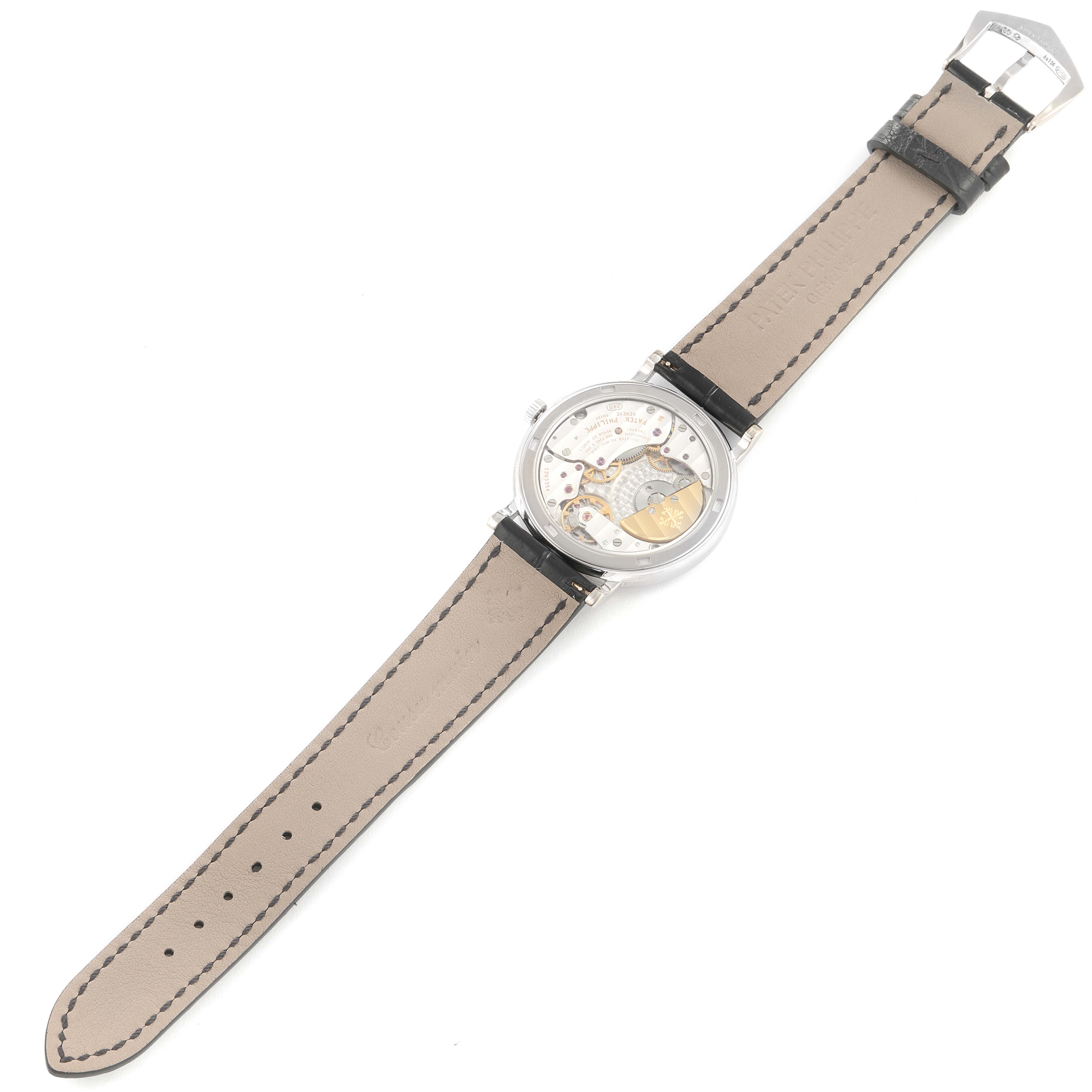 The image shows the back of a Patek Philippe Calatrava 5120G Men's White Gold White Dial 5120G Men's White Gold White Dial watch, displaying the movement and full beige strap.