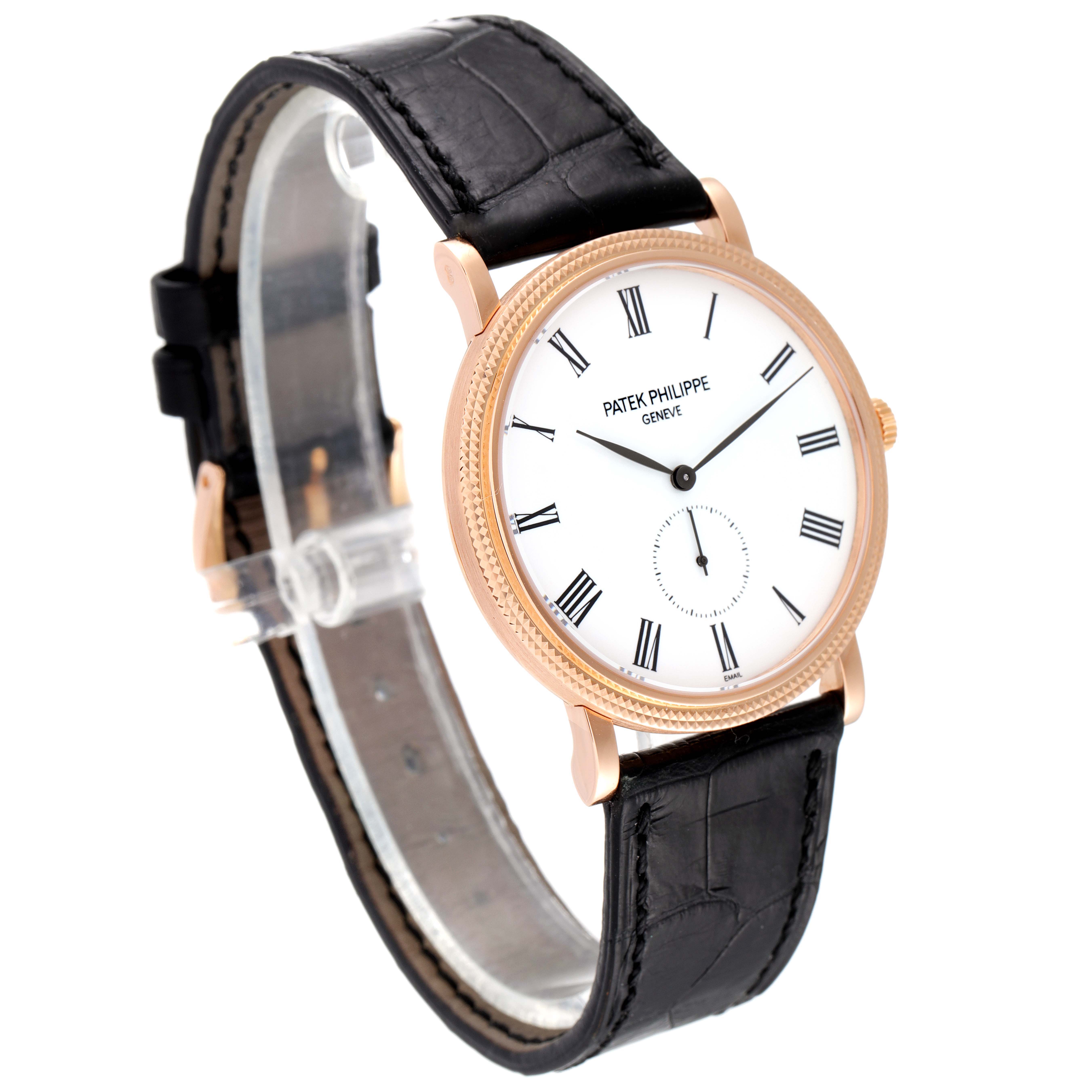 This image shows a Patek Philippe Calatrava 5116R Men's Rose Gold White Dial 5116R Men's Rose Gold White Dial watch at an angle highlighting its face, bezel, and leather strap.