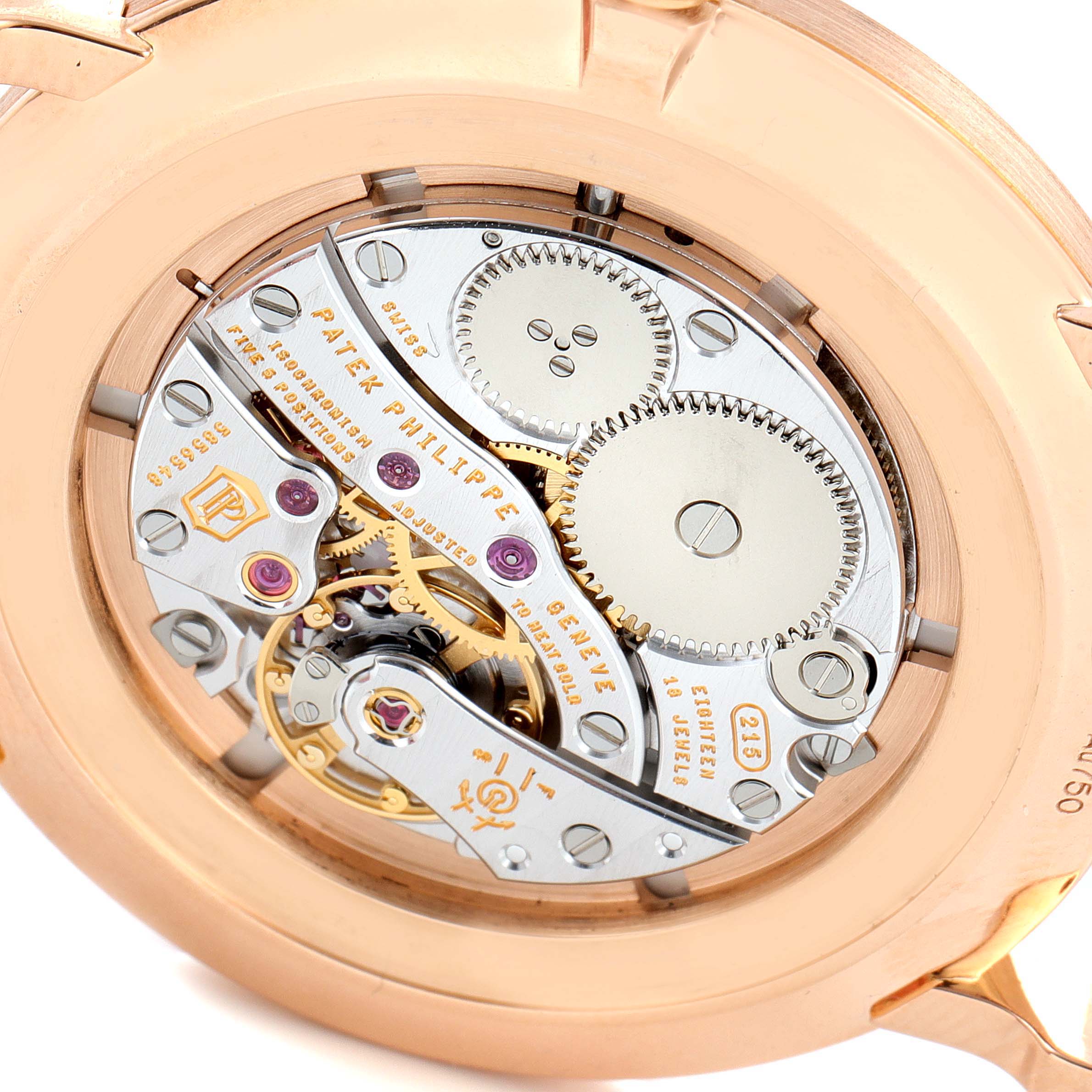 The image shows the backside of a Patek Philippe Calatrava 5116R Men's Rose Gold White Dial 5116R Men's Rose Gold White Dial watch, revealing its intricate movement mechanism.