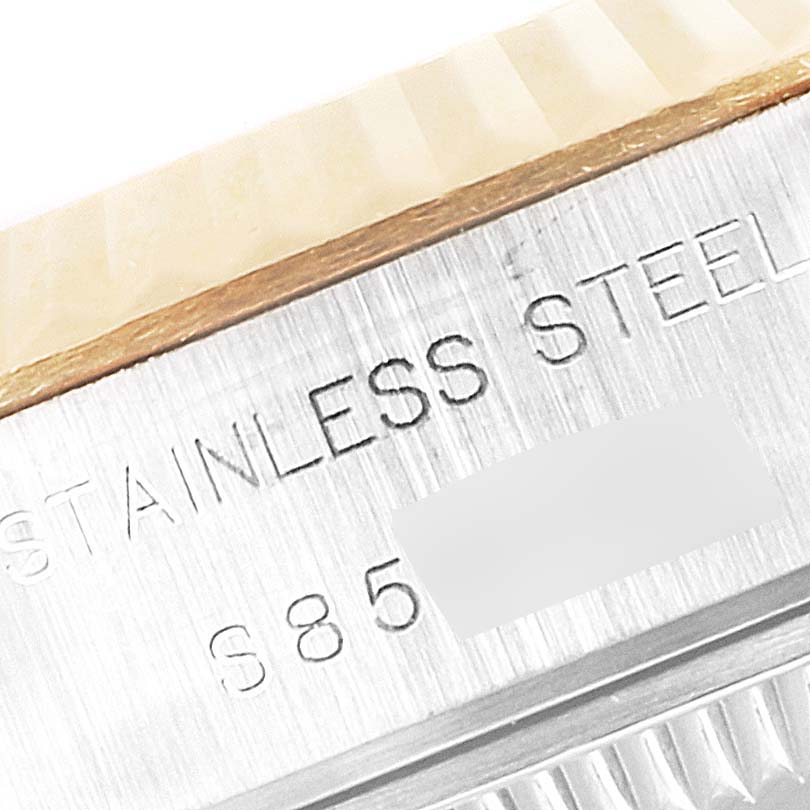 Close-up of the side of a Rolex Datejust 69173 Women's Steel and Gold (two tone) Champagne Dial 69173 Women's Steel and Gold (two tone) Champagne Dial, showing the fluted bezel and "STAINLESS STEEL" engraving.