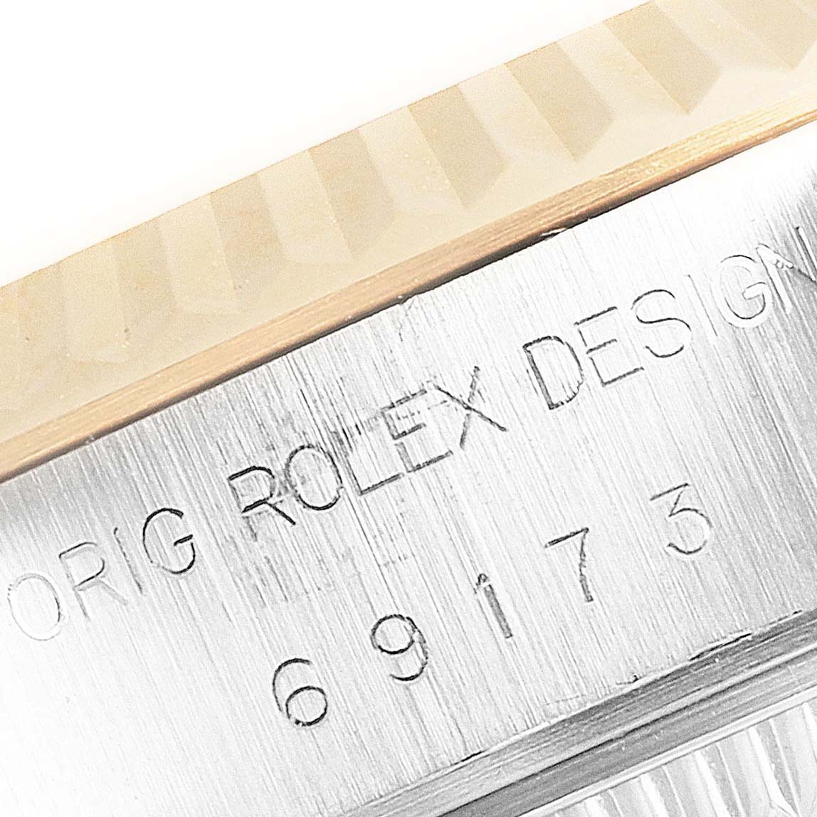 The image shows a close-up of the bezel and case body of a Rolex Datejust 69173 Women's Steel and Gold (two tone) Champagne Dial 69173 Women's Steel and Gold (two tone) Champagne Dial, focusing on the model engraving.
