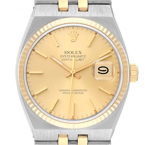 The image shows a front view of a Rolex Oysterquartz 17013 Men's Steel and Gold (two tone) Champagne Dial 17013 Men's Steel and Gold (two tone) Champagne Dial Datejust watch, displaying the dial, hands, crown, and part of the bracelet.