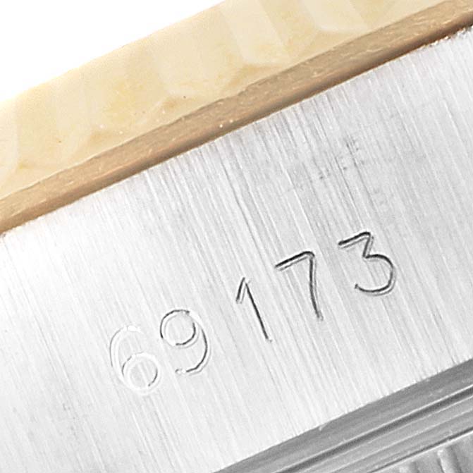 The image shows a close-up of the engraved Reference Number on the side of the bezel and case of a Rolex Datejust 69173 Women's Steel and Gold (two tone) Champagne Dial 69173 Women's Steel and Gold (two tone) Champagne Dial.