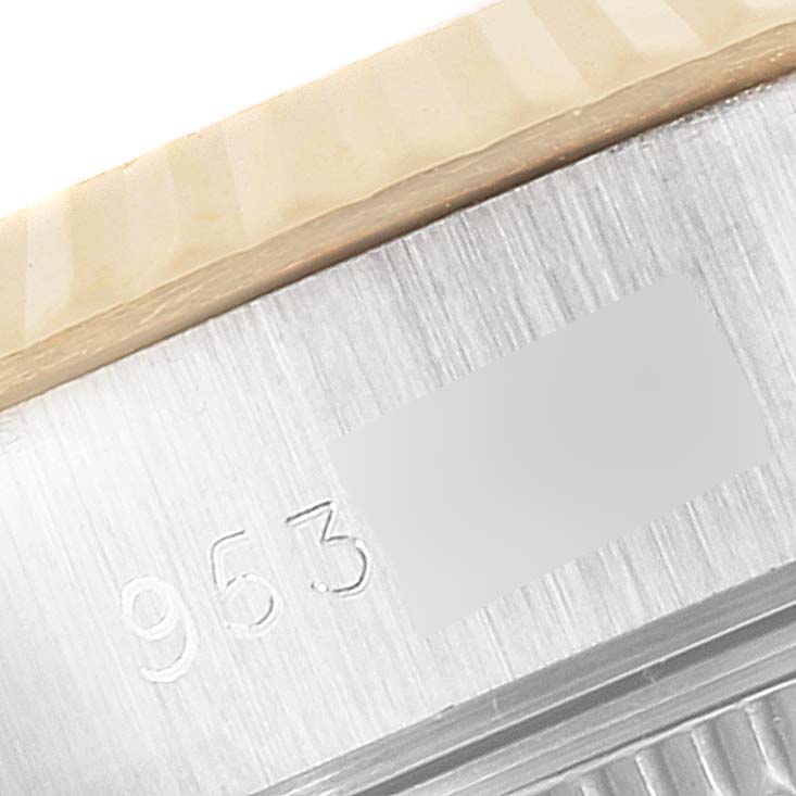 The image shows a close-up of the fluted bezel and a part of the case with serial numbers on a Rolex Datejust 69173 Women's Steel and Gold (two tone) Champagne Dial 69173 Women's Steel and Gold (two tone) Champagne Dial watch.