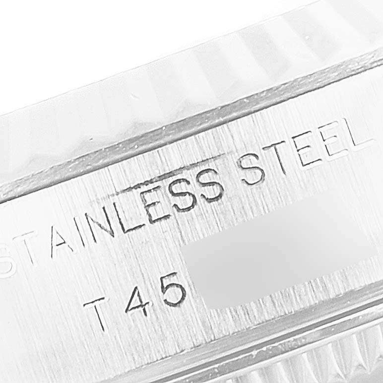 This image shows a close-up of the case back and part of the bezel of a Rolex Datejust 69174 Women's Stainless Steel Silver Dial 69174 Women's Stainless Steel Silver Dial, highlighting the "STAINLESS STEEL" engraving.