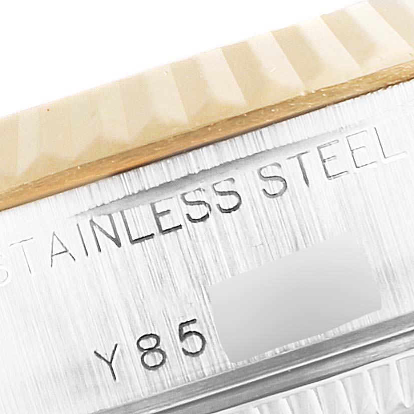 This close-up image shows the side of the Rolex Datejust 79173 Women's Steel and Gold (two tone) Mother of Pearl Dial 79173 Women's Steel and Gold (two tone) Mother of Pearl Dial watch, highlighting the bezel and part of the engraved stainless steel casing.