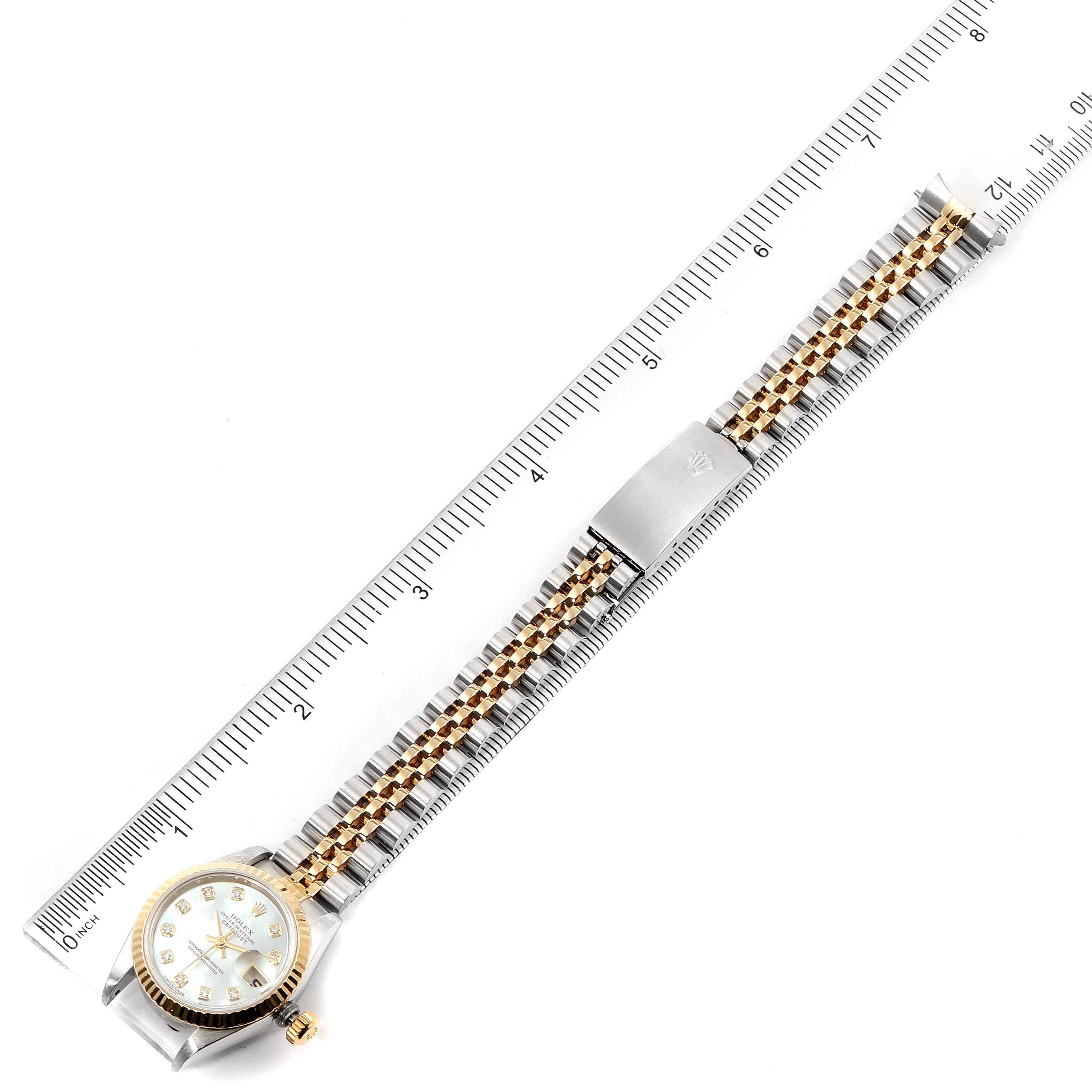 The image shows the entire Rolex Datejust 79173 Women's Steel and Gold (two tone) Mother of Pearl Dial 79173 Women's Steel and Gold (two tone) Mother of Pearl Dial watch stretched out against a ruler, displaying the case, band, and clasp.