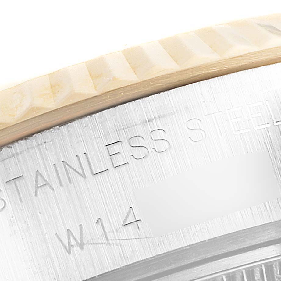 This close-up image shows the bezel and part of the casing of a Rolex Datejust 69173 Women's Steel and Gold (two tone) Champagne Dial 69173 Women's Steel and Gold (two tone) Champagne Dial model, with "STAINLESS STEEL" engraved.