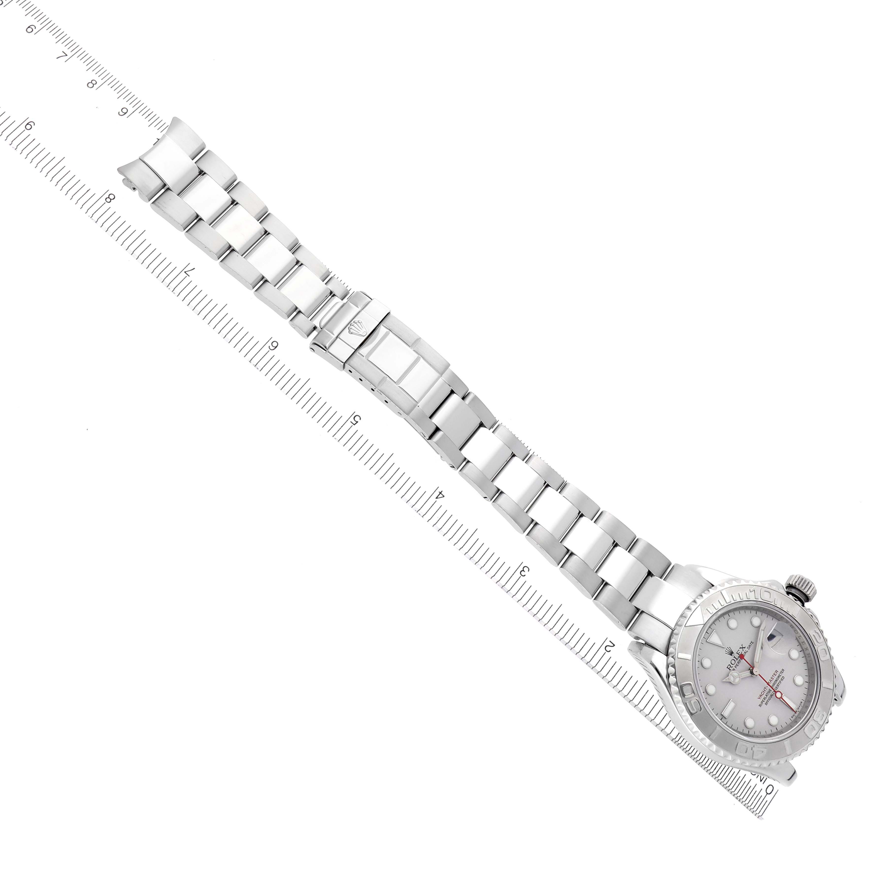 The Rolex Yacht-Master 16622 Men's Stainless Steel Silver Dial 16622 Men's Stainless Steel Silver Dial watch is displayed from a top angle, showing the full bracelet and dial next to a measuring scale.